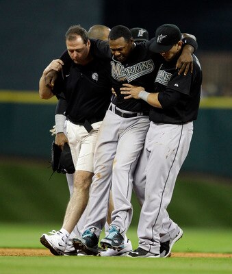 HOUSTON - APRIL 08:  Shortstop Hanley Ramirez #2 of the Florida Marlins has to be helped off the field after Bill Hall #22 of the Houston Asrtros slid into second base to interupt the double play at Minute Maid Park on April 8, 2011 in Houston, Texas.  (P