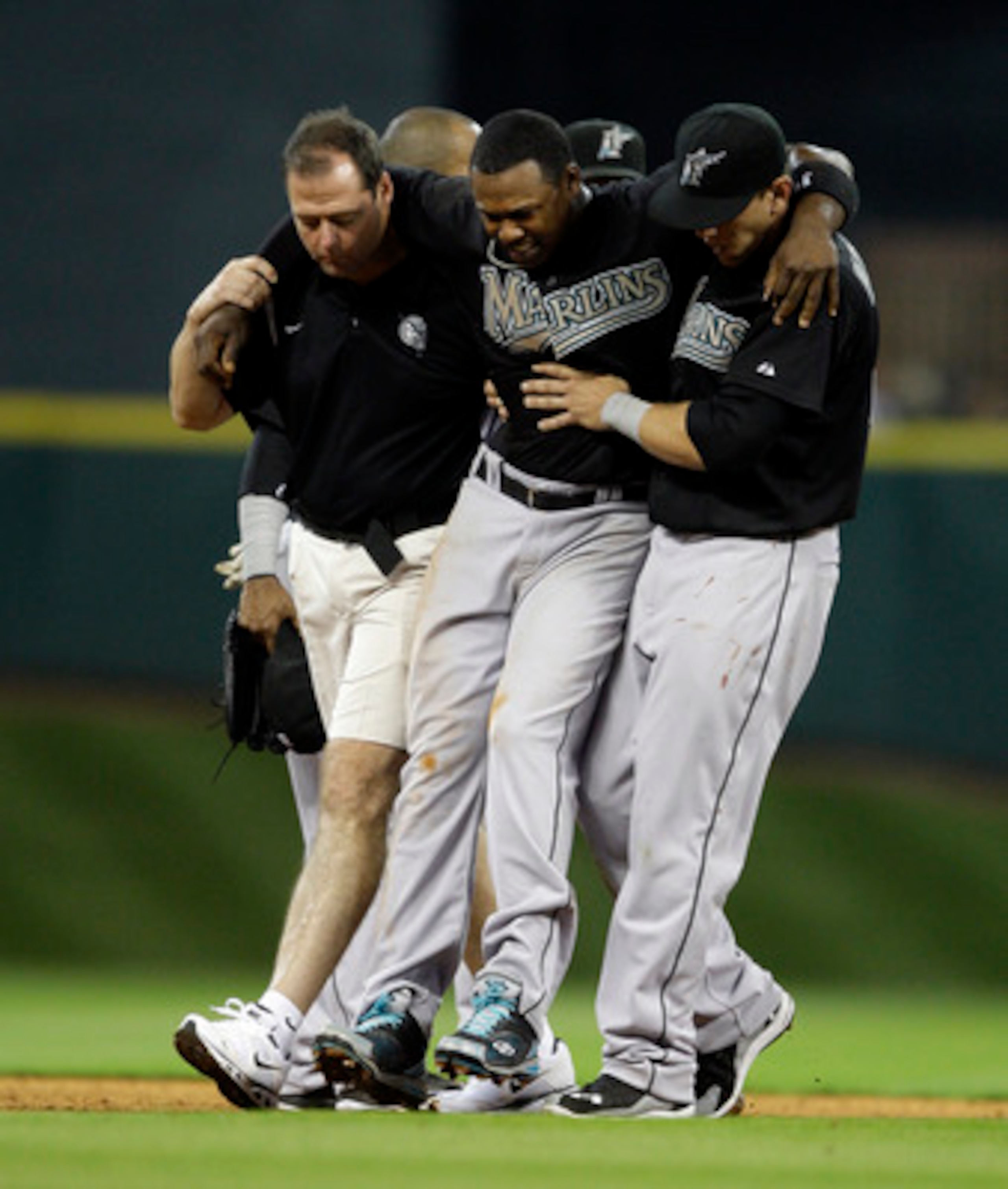 HOUSTON - APRIL 08:  Shortstop Hanley Ramirez #2 of the Florida Marlins has to be helped off the field after Bill Hall #22 of the Houston Asrtros slid into second base to interupt the double play at Minute Maid Park on April 8, 2011 in Houston, Texas.  (P