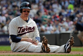 MINNEAPOLIS, MN - APRIL 24: Justin Morneau #33 of the Minnesota Twins reacts after being tagged out at home plate for the final out of the third inning against the Cleveland Indians during their game on April 24, 2011 at Target Field in Minneapolis, Minne