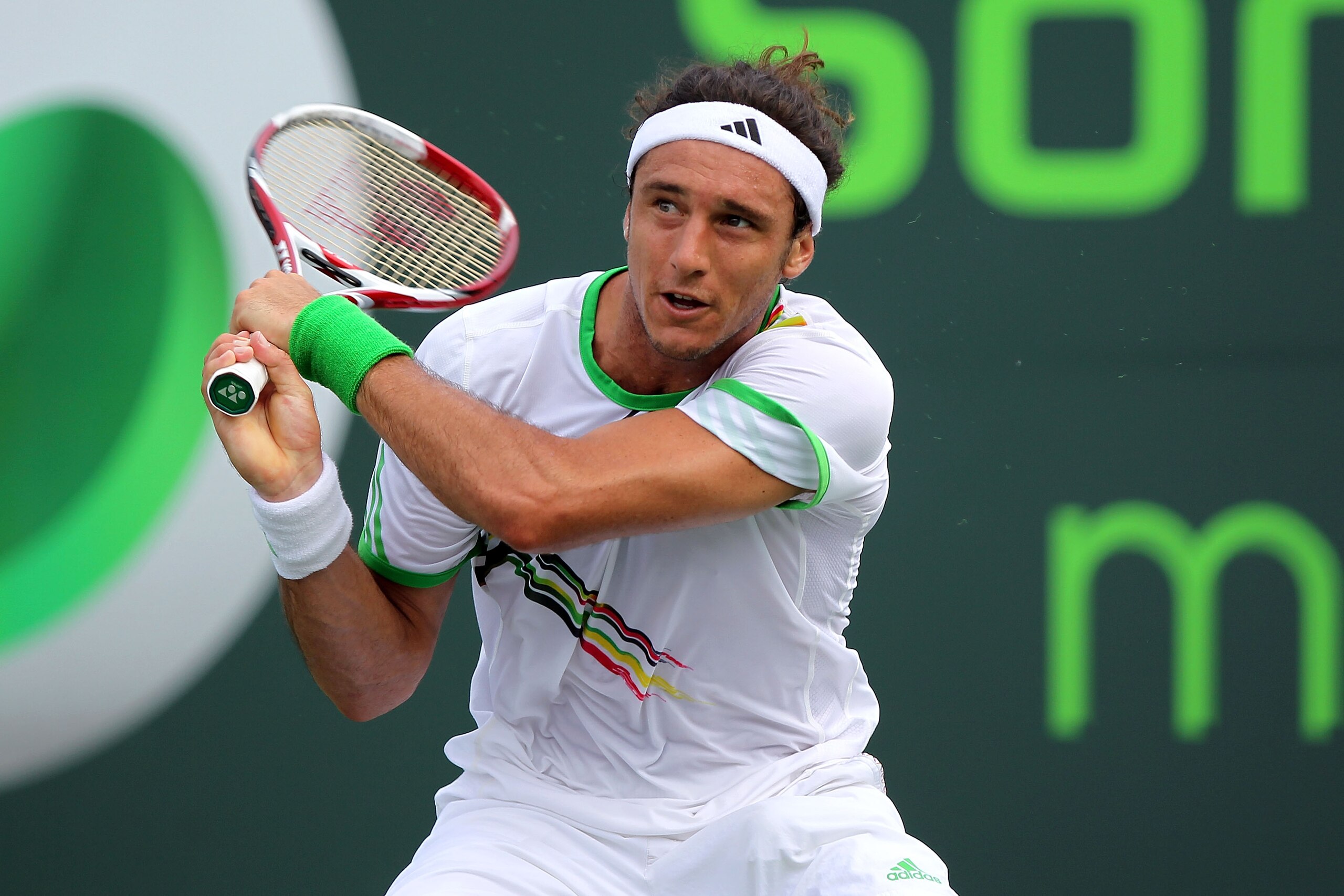 KEY BISCAYNE, FL - MARCH 28:  Juan Monaco of Argentina follows through on a return against Roger Federer of Switzerland during the Sony Ericsson Open at Crandon Park Tennis Center on March 28, 2011 in Key Biscayne, Florida.  (Photo by Mike Ehrmann/Getty I