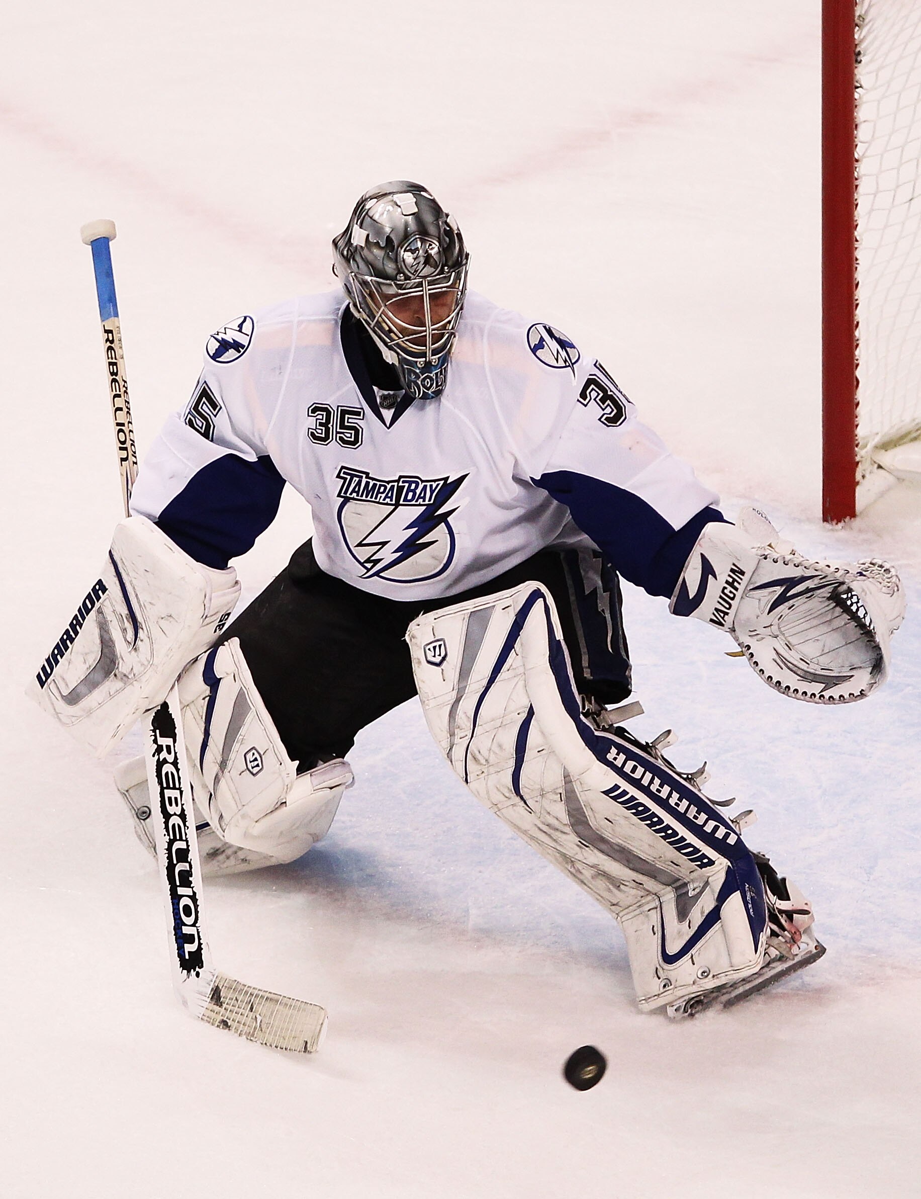 BOSTON, MA - MAY 17:  Dwayne Roloson #35 of the Tampa Bay Lightning attempts to block a shot by the Boston Bruins in Game Two of the Eastern Conference Finals during the 2011 NHL Stanley Cup Playoffs at TD Garden on May 17, 2011 in Boston, Massachusetts.
