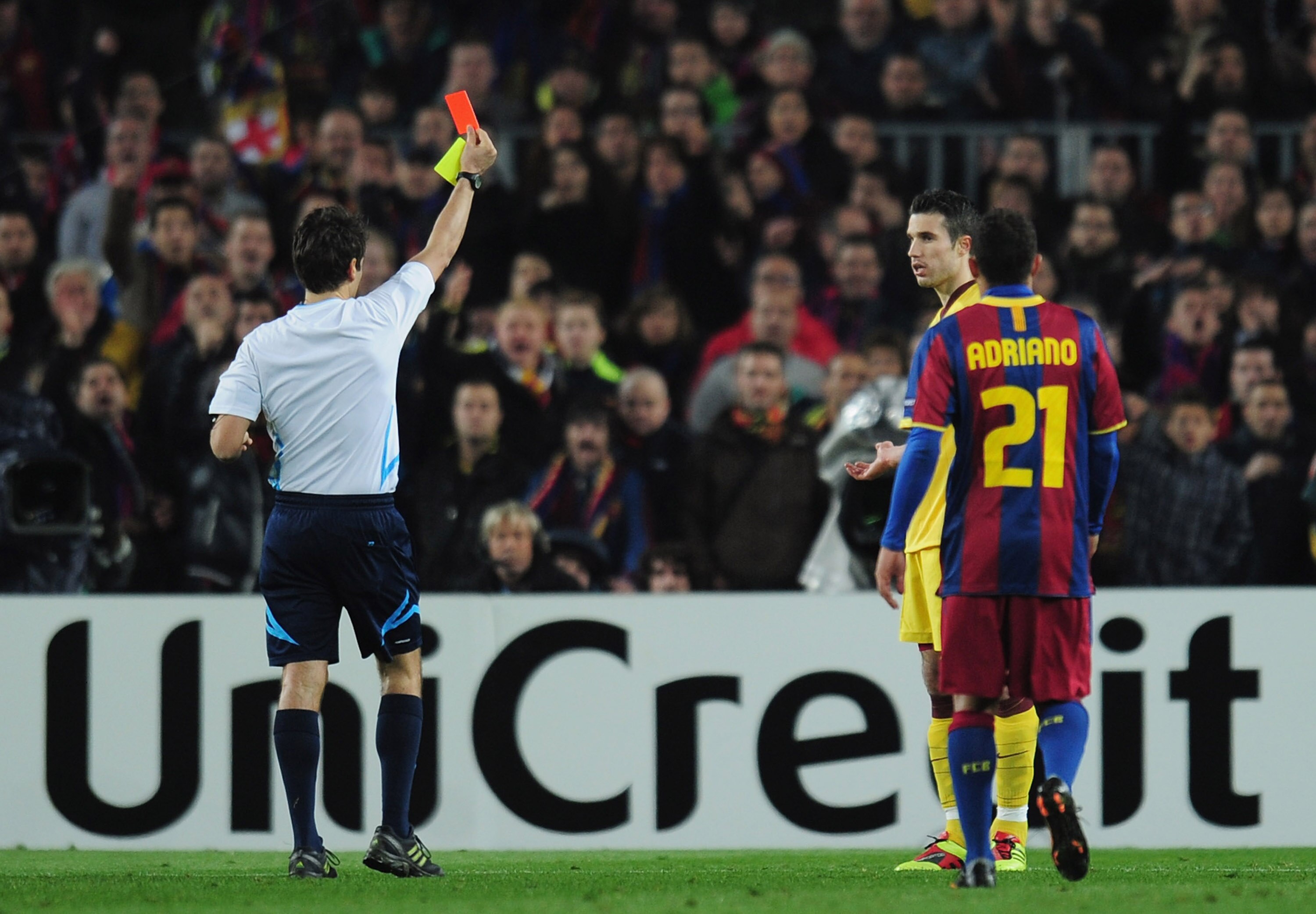 BARCELONA, SPAIN - MARCH 08:  Robin van Persie of Arsenal receives a red card from referee Massimo Busacca during the UEFA Champions League round of 16 second leg match between Barcelona and Arsenal at the Nou Camp Stadium on March 8, 2011 in Barcelona, S