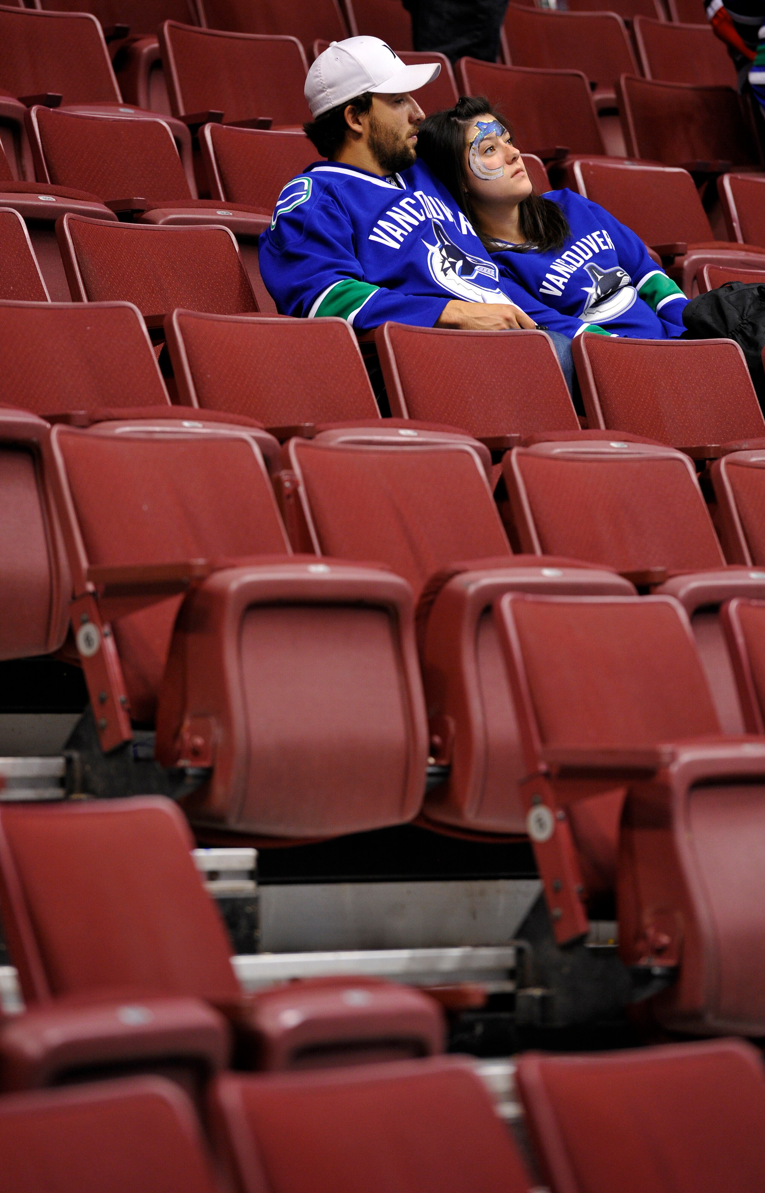 VANCOUVER, CANADA - MAY 11: A pair of Vancouver Canucks fans sit in the stands after the Canucks lost 5-1 to the Chicago Blackhawks in Game Six of the Western Conference Semifinals and the series 4-2 during the 2010 NHL Stanley Cup Playoffs on May 11, 20 VANCOUVER, CANADA - MAY 11: A pair of Vancouver Canucks fans sit in the stands after the Canucks lost 5-1 to the Chicago Blackhawks in Game Six of the Western Conference Semifinals and the series 4-2 during the 2010 NHL Stanley Cup Playoffs on May 11, 20