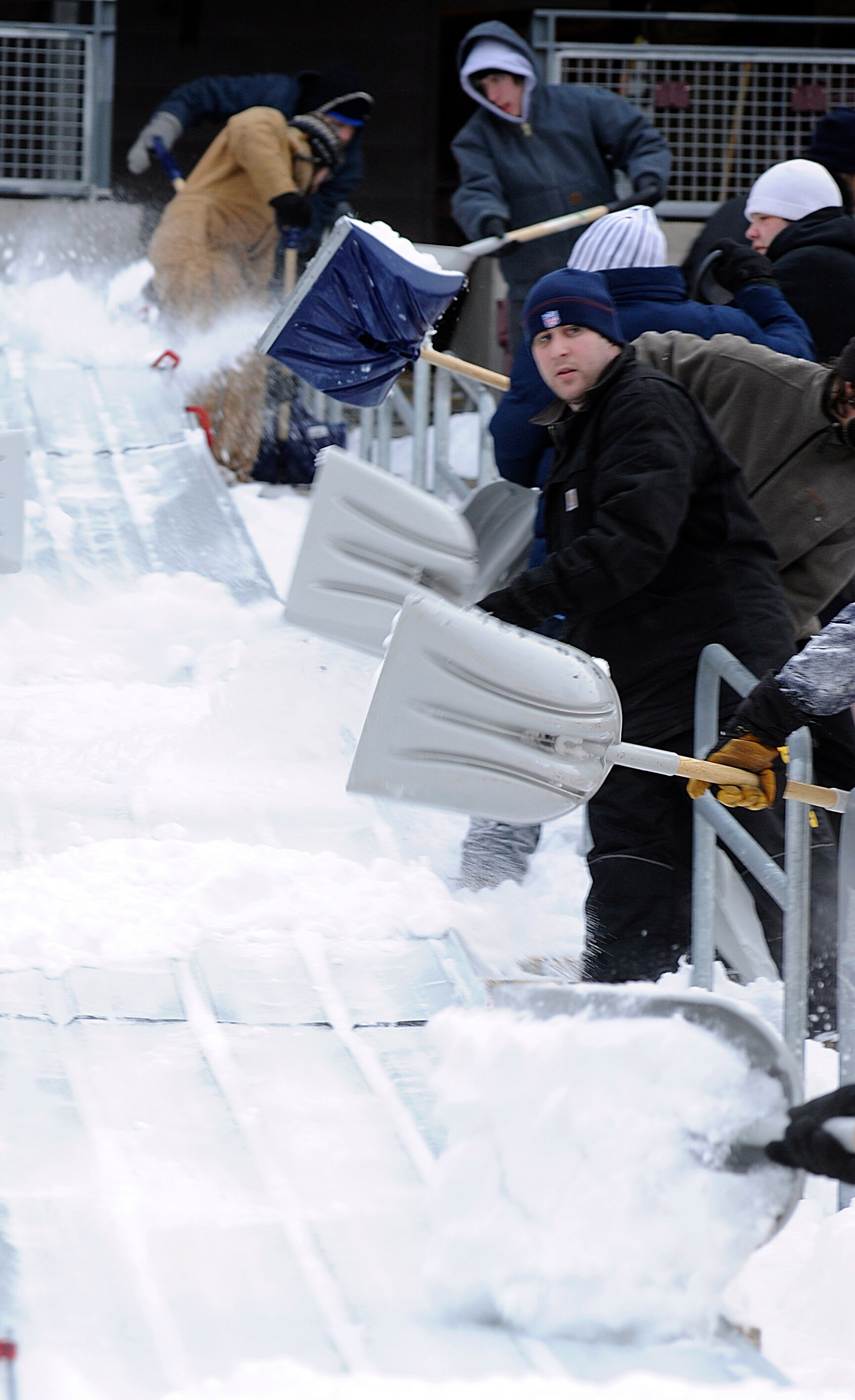 MINNEAPOLIS, MN - DECEMBER 15: Workers shovel snow on to a slide that brought the snow down to field level as TCF Bank Stadium prepares for a potential monday night football game between the Minnesota Vikings and Chicago Bears on December 15, 2010 in Minn