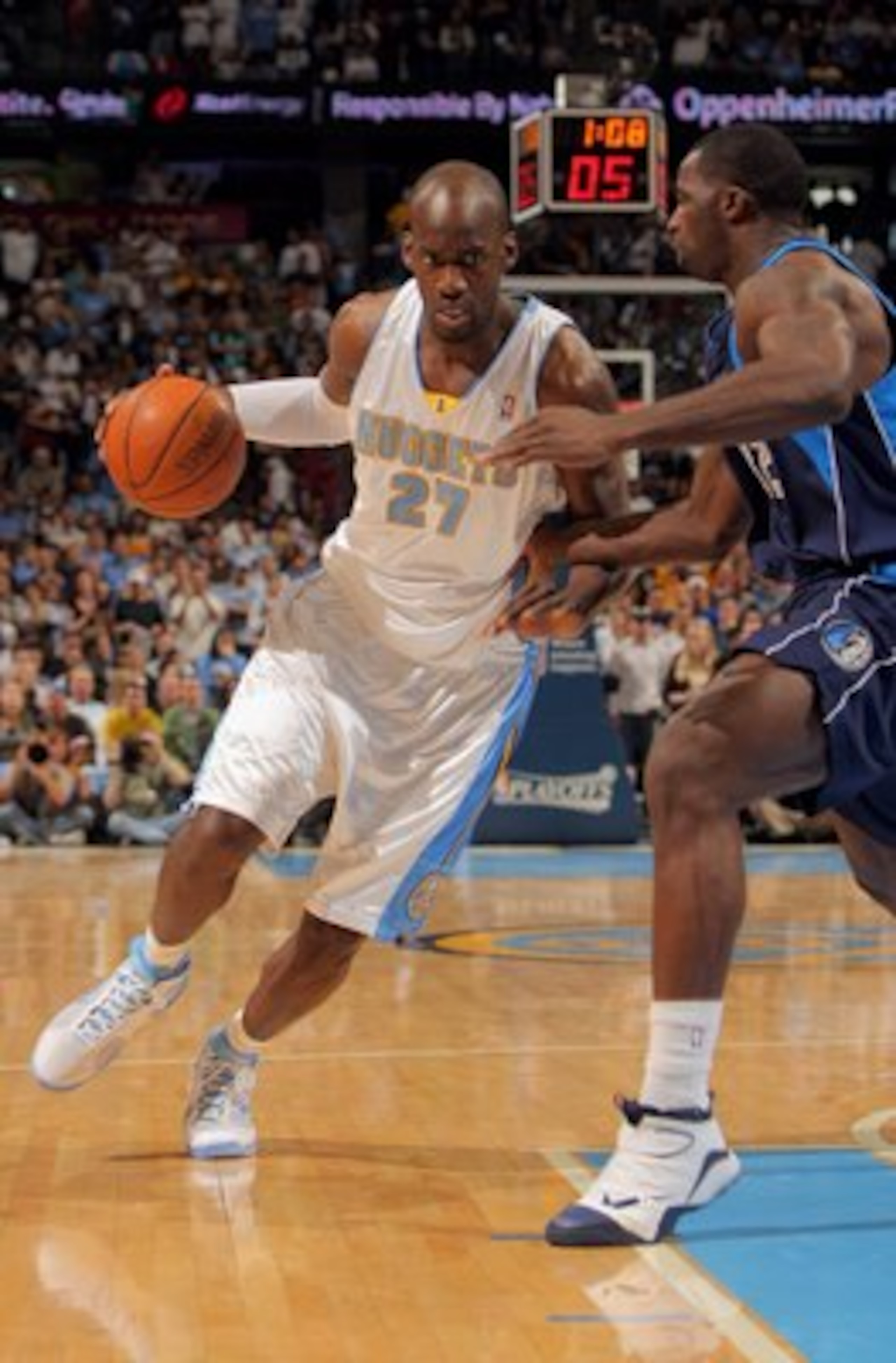 DENVER - MAY 03:  Johan Petro #27 of the Denver Nuggets drives against the defense of Brandon Bass #32 of the Dallas Mavericks in Game One of the Western Conference Semifinals during the 2009 NBA Playoffs at Pepsi Center on May 3, 2009 in Denver, Colorado