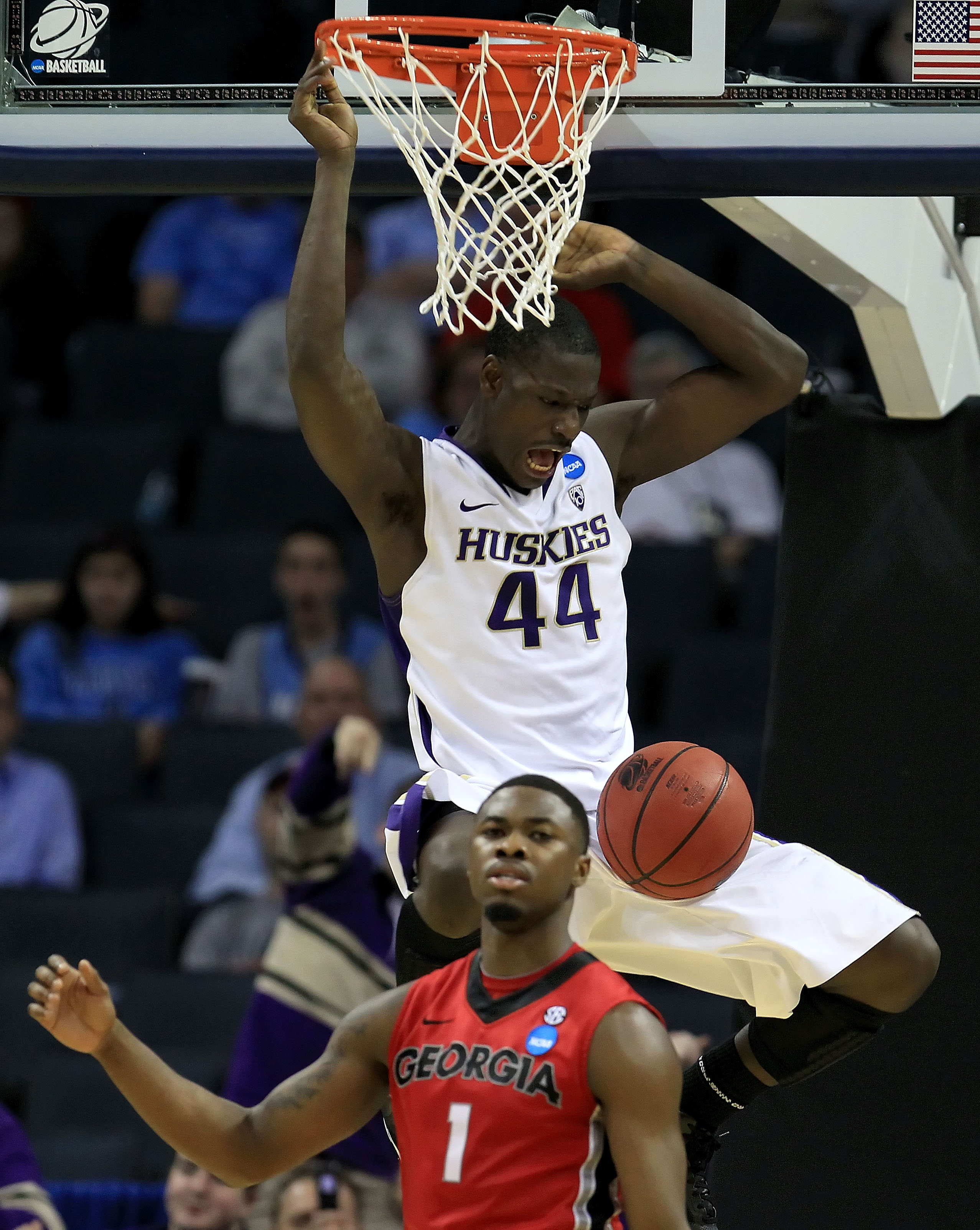 CHARLOTTE, NC - MARCH 18:  Darnell Gant #44 of the Washington Huskies dunks the ball over Travis Leslie #1 of the Georgia Bulldogs in the second half during the second round of the 2011 NCAA men's basketball tournament at Time Warner Cable Arena on March