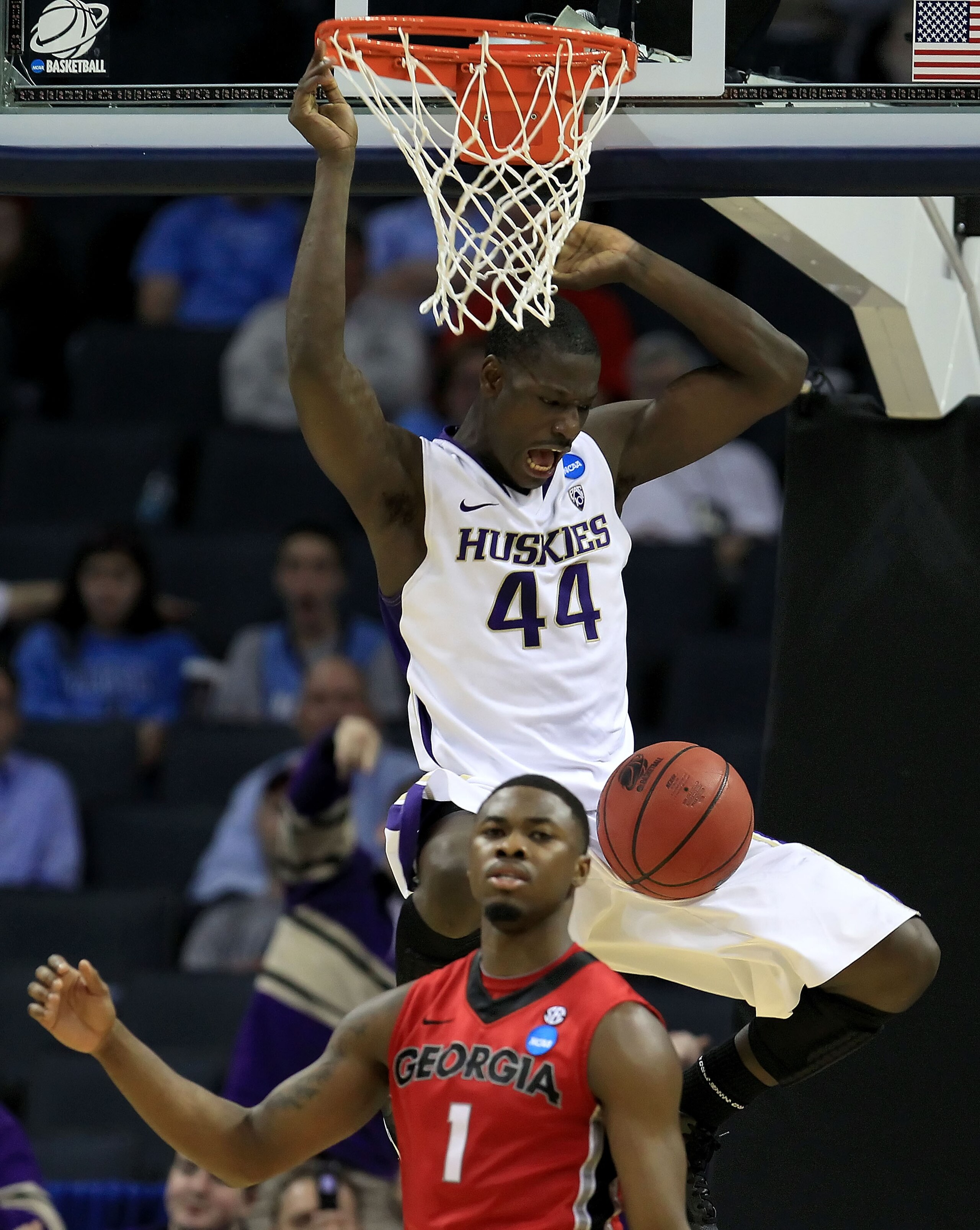 CHARLOTTE, NC - MARCH 18:  Darnell Gant #44 of the Washington Huskies dunks the ball over Travis Leslie #1 of the Georgia Bulldogs in the second half during the second round of the 2011 NCAA men's basketball tournament at Time Warner Cable Arena on March