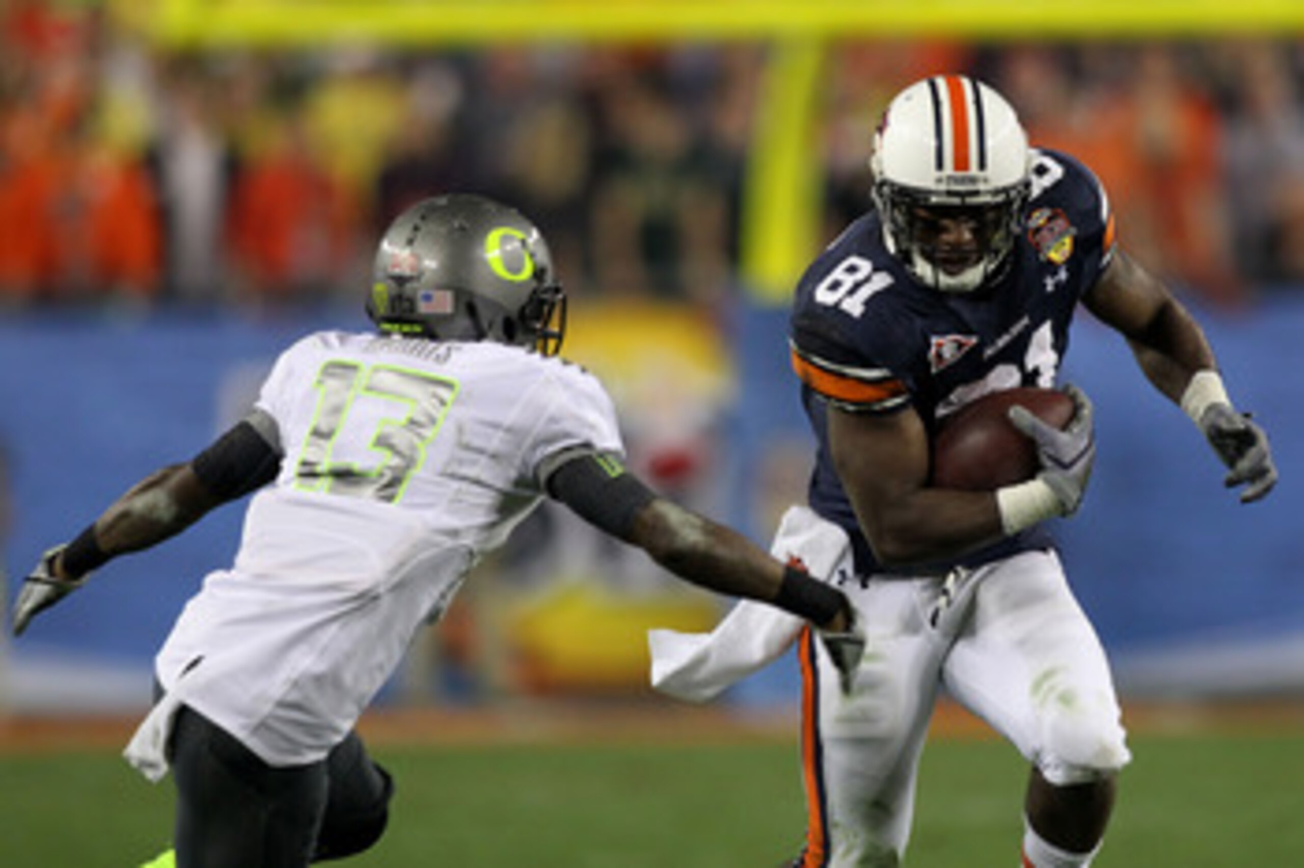 GLENDALE, AZ - JANUARY 10:  Terrell Zachery #81 of the Auburn Tigers runs against Cliff Harris #13 of the Oregon Ducks during the Tostitos BCS National Championship Game at University of Phoenix Stadium on January 10, 2011 in Glendale, Arizona.  (Photo by