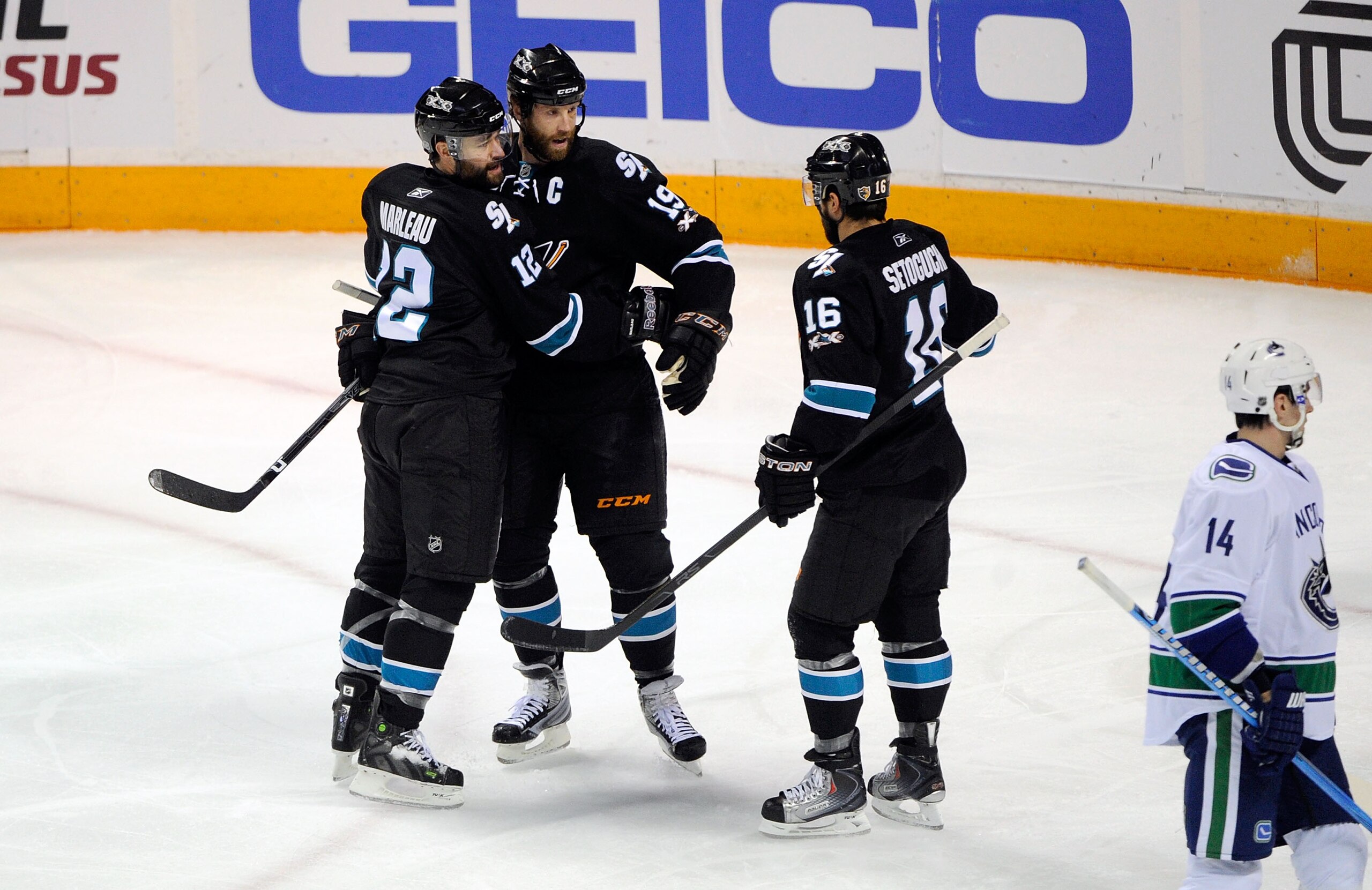 SAN JOSE, CA - MAY 20:  Patrick Marleau #12, Joe Thornton #19 and Devin Setoguchi #16 of the San Jose Sharks celebrate Marleau's first goal of the first period as Alex Burrows #14 of the Vancouver Canucks skates by in Game Three of the Western Conference