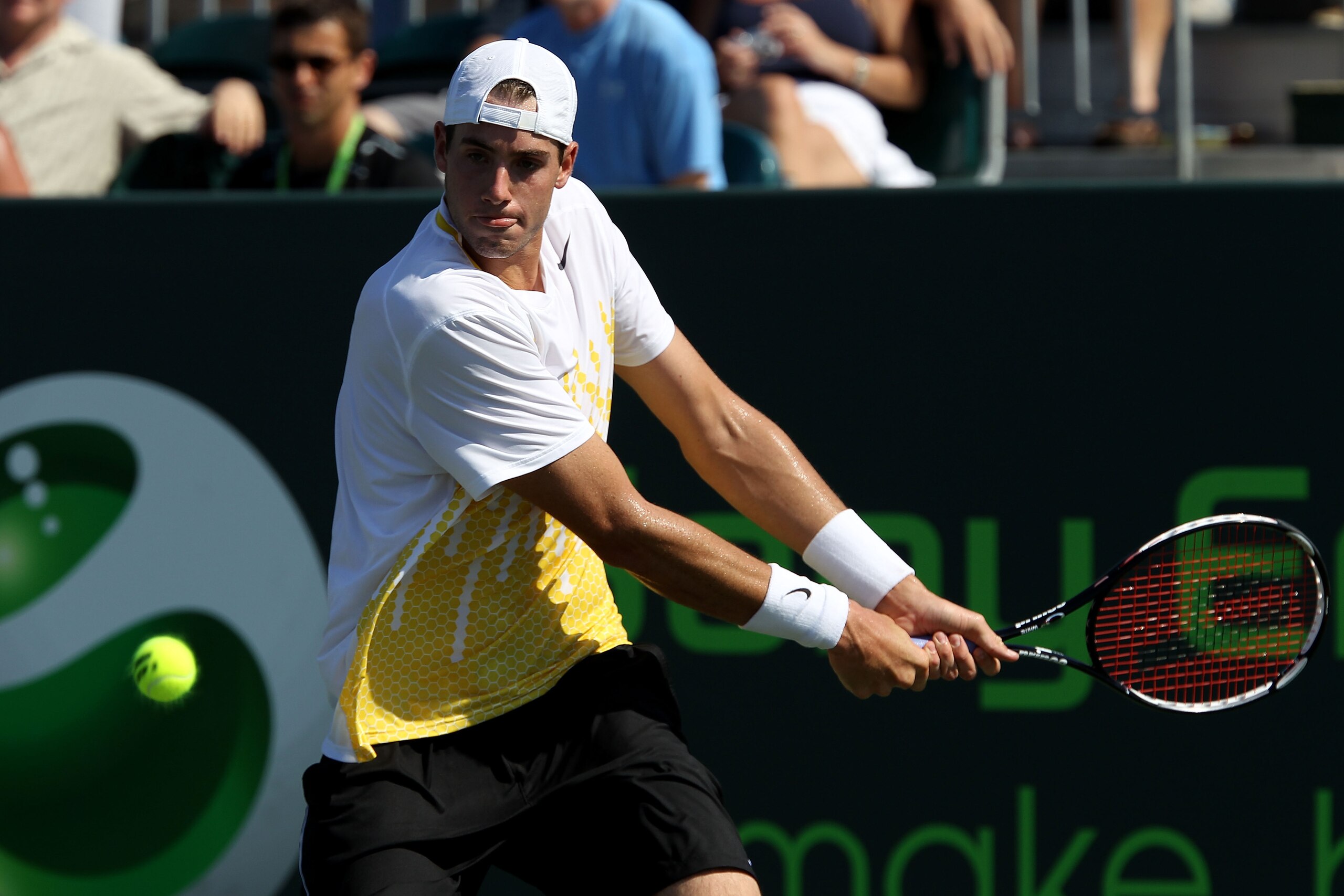 KEY BISCAYNE, FL - MARCH 27:  John Isner gets set to hit a backhand return against Alex Bogomolov Jr. during the Sony Ericsson Open at Crandon Park Tennis Center on March 27, 2011 in Key Biscayne, Florida.  (Photo by Clive Brunskill/Getty Images)