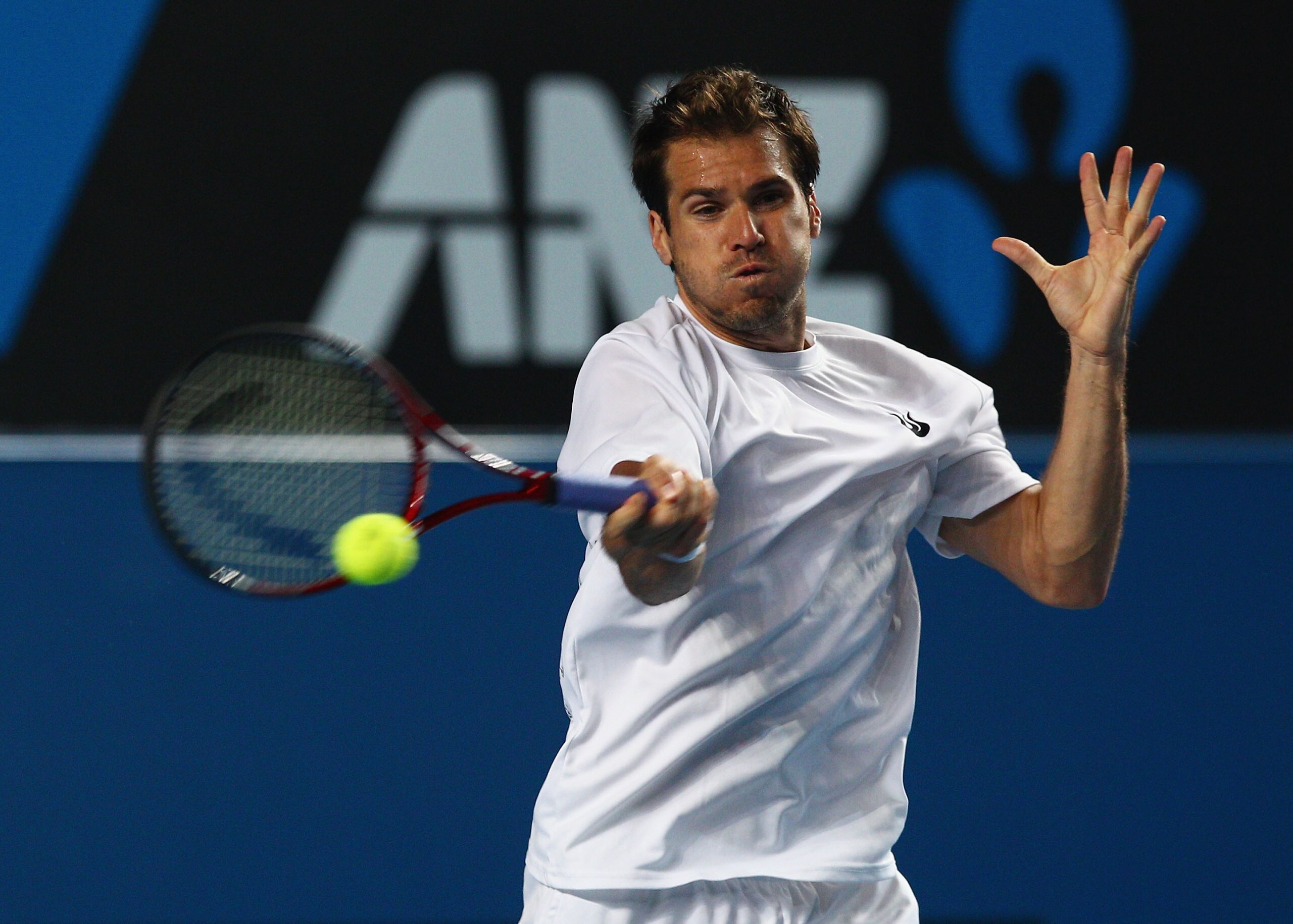 MELBOURNE, AUSTRALIA - JANUARY 23:  Tommy Haas of Germany plays a forehand in his third round doubles match against Jo-Wilfried Tsonga of France during day six of the 2010 Australian Open at Melbourne Park on January 23, 2010 in Melbourne, Australia.  (Ph