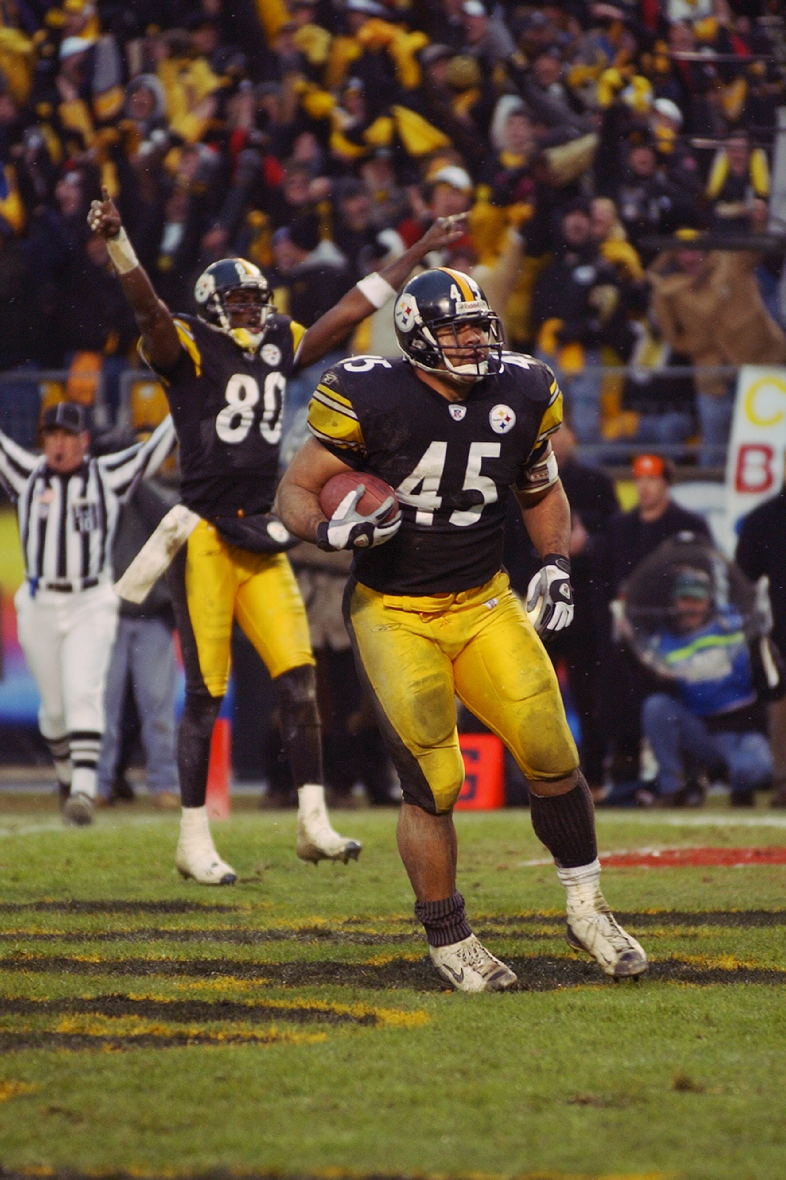 PITTSBURGH, PA - JANUARY 5:  Chris Fuamata-Ma'afala #45 of the Pittsburgh Steelers scores the game winning touchdown with a three yard run against the Cleveland Browns with :58 seconds remaining in the fourth quarter as teammate Plaxico Burress #80 celebr