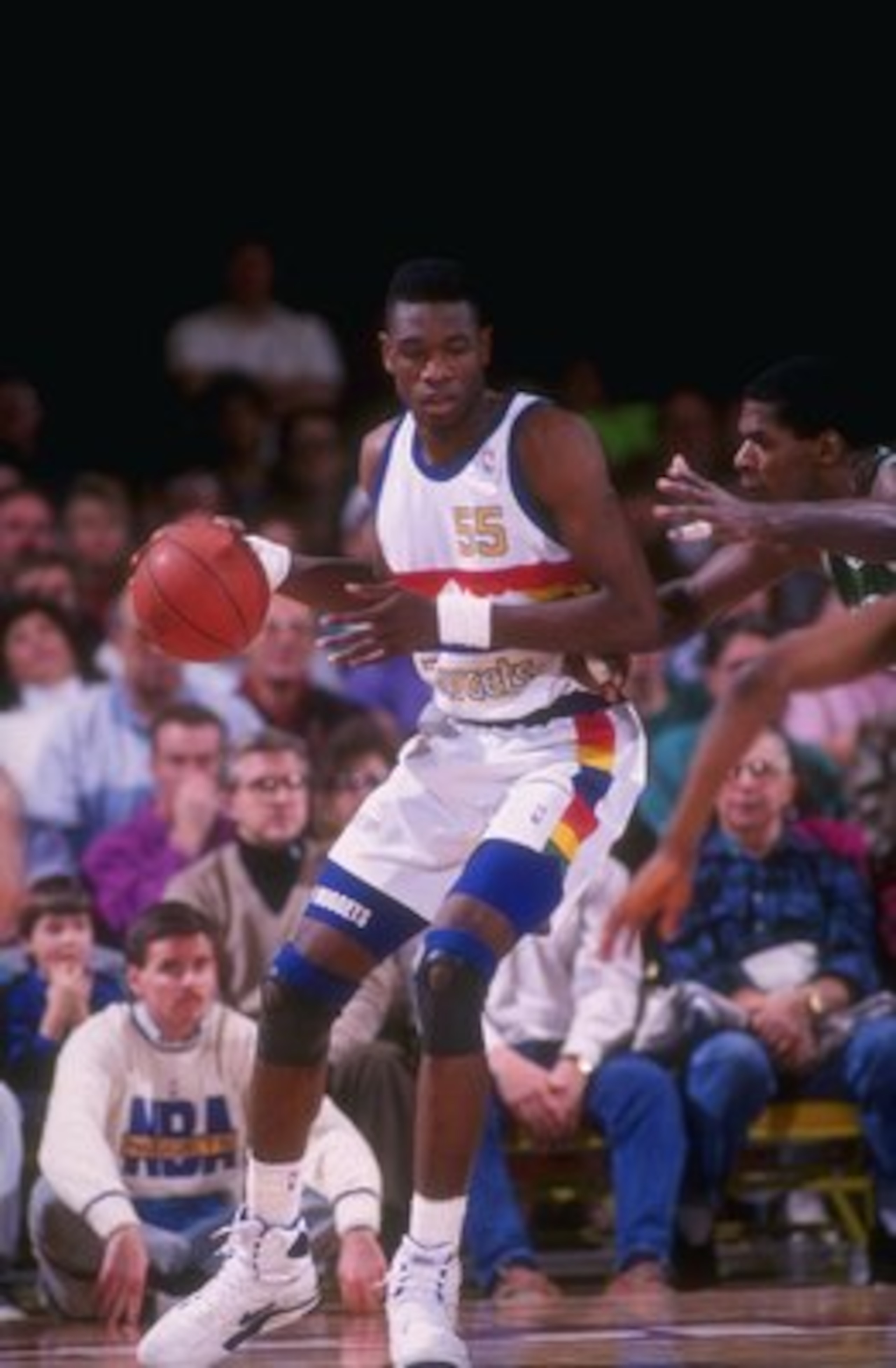 1991-1992:  Center Dikembe Mutombo of the Denver Nuggets moves the ball during a game at the McNichols Sports Arena in Denver, Colorado. Mandatory Credit: Tim DeFrisco  /Allsport Mandatory Credit: Tim DeFrisco  /Allsport