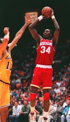 28 DEC 1993:  HOUSTON ROCKETS CENTER HAKEEM OLAJUWON PUTS A SHOT UP AGAINST THE LAKER''S VLADE DIVAC. Mandatory Credit: Glenn Cratty/ALLSPORT