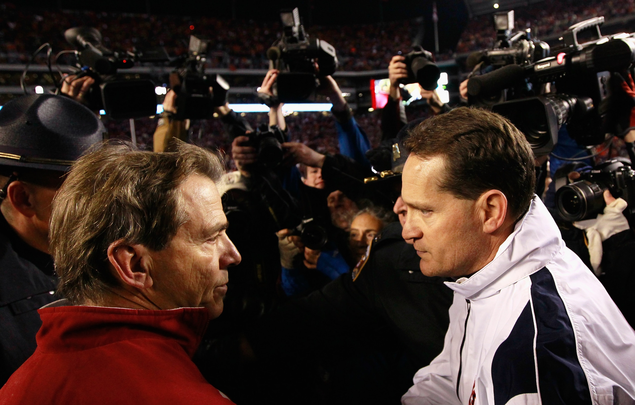 TUSCALOOSA, AL - NOVEMBER 26:  Head coach Gene Chizik of the Auburn Tigers is congratulated by head coach Nick Saban of the Alabama Crimson Tide after the Tigers 28-27 win at Bryant-Denny Stadium on November 26, 2010 in Tuscaloosa, Alabama.  (Photo by Kev