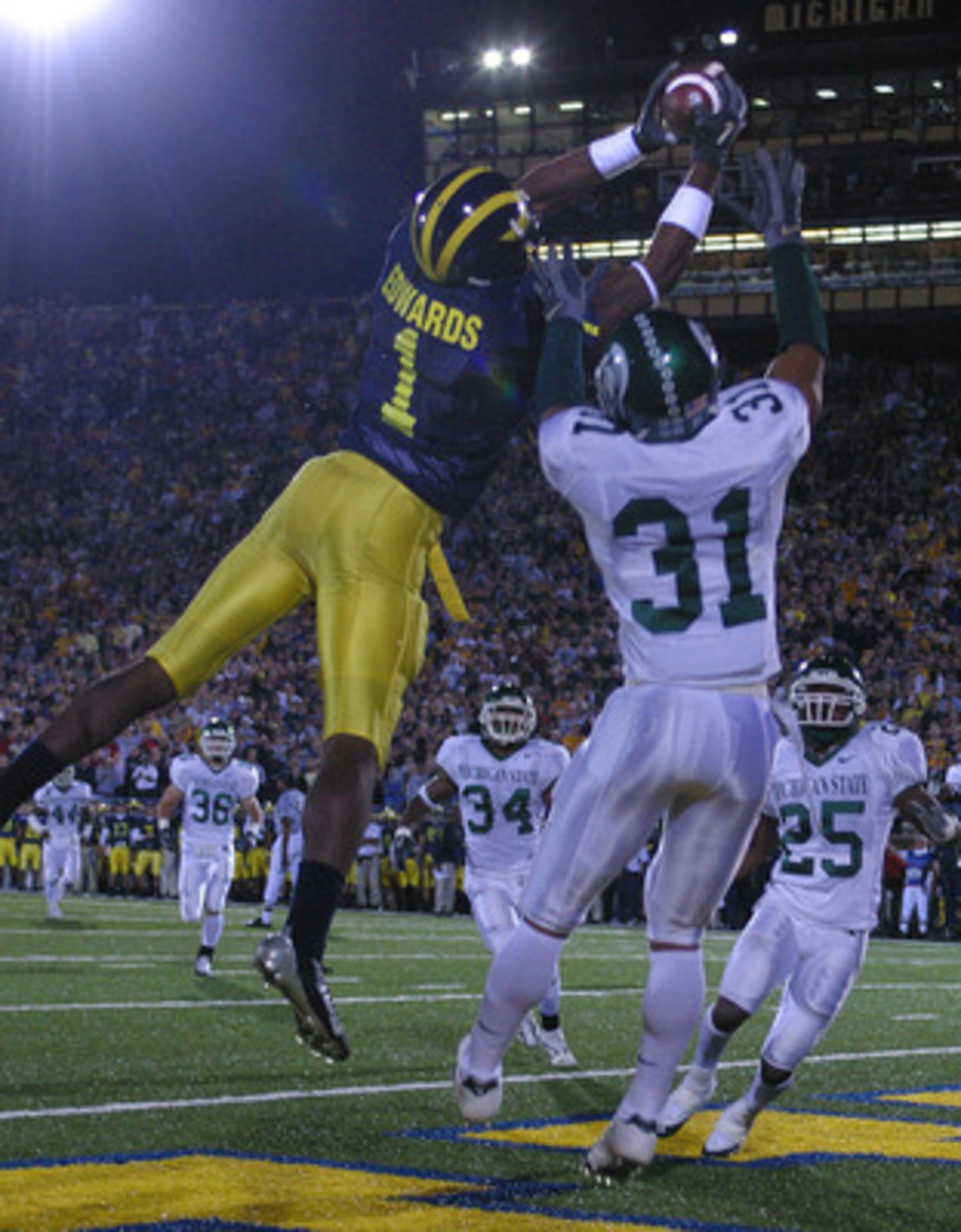 ANN ARBOR - October 30:  Wide receiver Braylon Edwards #1 of Michigan catches a touchdown pass defended by Jaren Hayes #31 of Michigan State at Michigan Stadium on October 30, 2004 in Ann Arbor, Michigan.  The Michigan Wolverines defeated the Michigan Sta