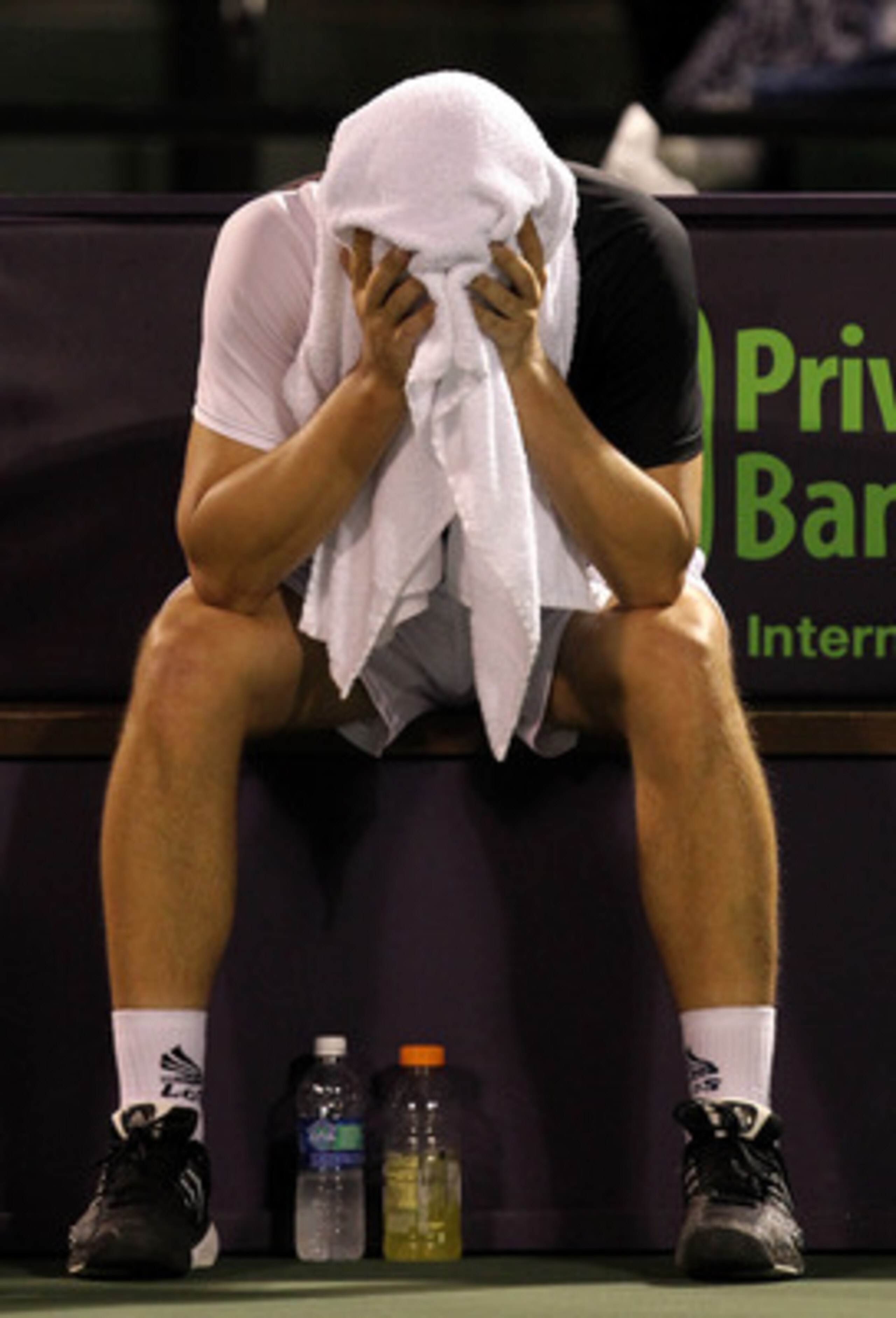 KEY BISCAYNE, FL - APRIL 01:  Mikhail Youzhny of Russia put a towel over his face while playing against Robin Soderling of Switzerland during day ten of the 2010 Sony Ericsson Open at Crandon Park Tennis Center on April 1, 2010 in Key Biscayne, Florida.