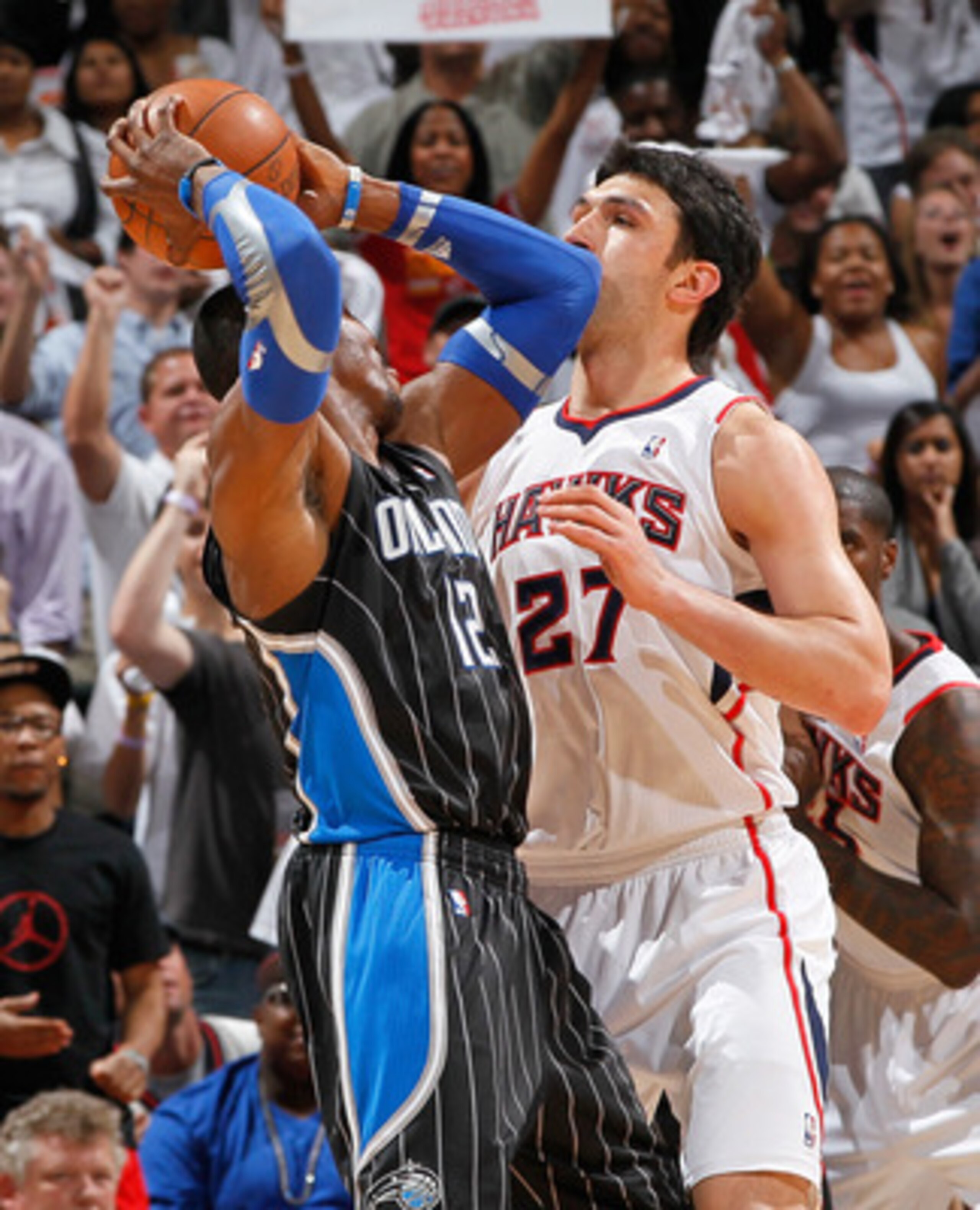 ATLANTA, GA - APRIL 28: Dwight Howard #12 of the Orlando Magic against Zaza Pachulia #27 of the Atlanta Hawks during Game Six of the Eastern Conference Quarterfinals in the 2011 NBA Playoffs at Philips Arena on April 28, 2011 in Atlanta, Georgia. NOTE T ATLANTA, GA - APRIL 28: Dwight Howard #12 of the Orlando Magic against Zaza Pachulia #27 of the Atlanta Hawks during Game Six of the Eastern Conference Quarterfinals in the 2011 NBA Playoffs at Philips Arena on April 28, 2011 in Atlanta, Georgia. NOTE T