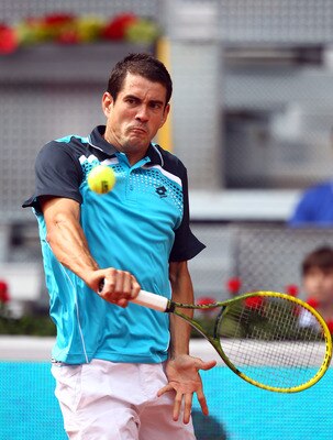 MADRID, SPAIN - MAY 01:  Guillermo Garcia-Lopez of Spain plays a backhand in his match against Stanislas Wawrinka of Switzerland during day two of the Mutua Madrilena Madrid Open Tennis on May 1, 2011 in Madrid, Spain.  (Photo by Julian Finney/Getty Image