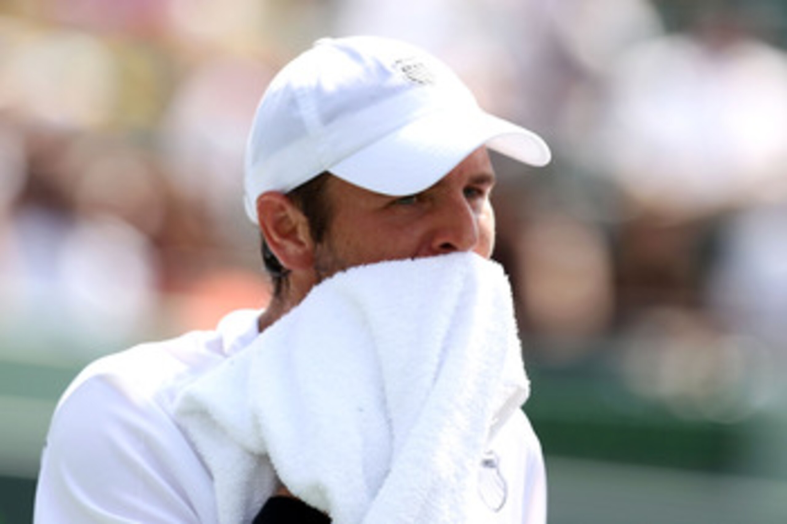 KEY BISCAYNE, FL - APRIL 01:  Mardy Fish wipes his face with a towel against Novak Djokovic of Serbia during their semifinal match at the Sony Ericsson Open at Crandon Park Tennis Center on April 1, 2011 in Key Biscayne, Florida.  (Photo by Al Bello/Getty