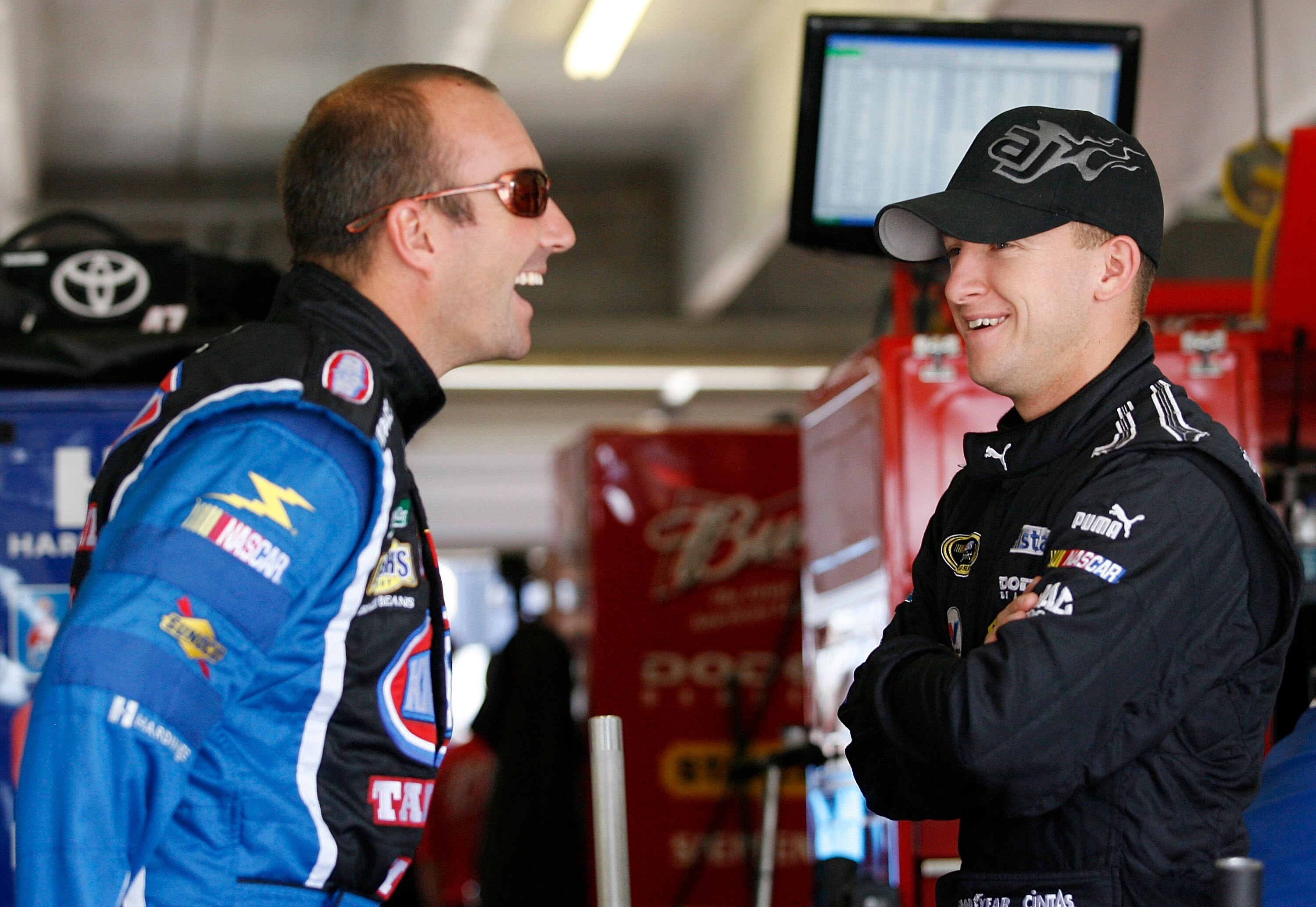 ATLANTA - MARCH 06:  Marcos Ambrose, driver of the #47 Kingsford/Clorox/Little Debbie Toyota (L). talks with A.J. Allmendinger, driver of the #44 Charter Dodge, in the garage prior to practice for the NASCAR Sprint Cup Series Kobalt Tools 500 at the Atlan