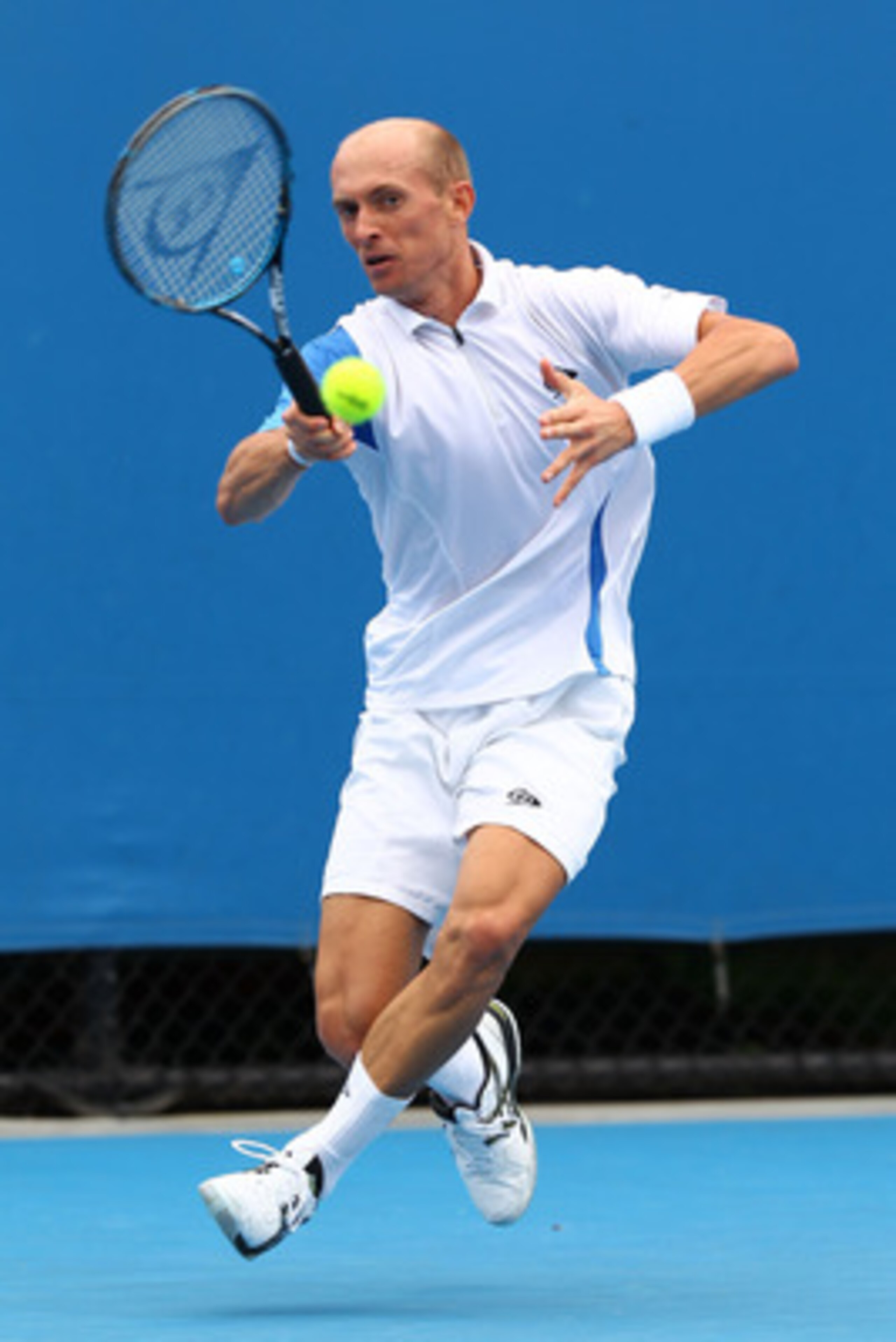 MELBOURNE, AUSTRALIA - JANUARY 17:  Nikolay Davydenko of Russia plays a forehand in his first round match against Florian Mayer of Germany during day one of the 2011 Australian Open at Melbourne Park on January 17, 2011 in Melbourne, Australia.  (Photo by
