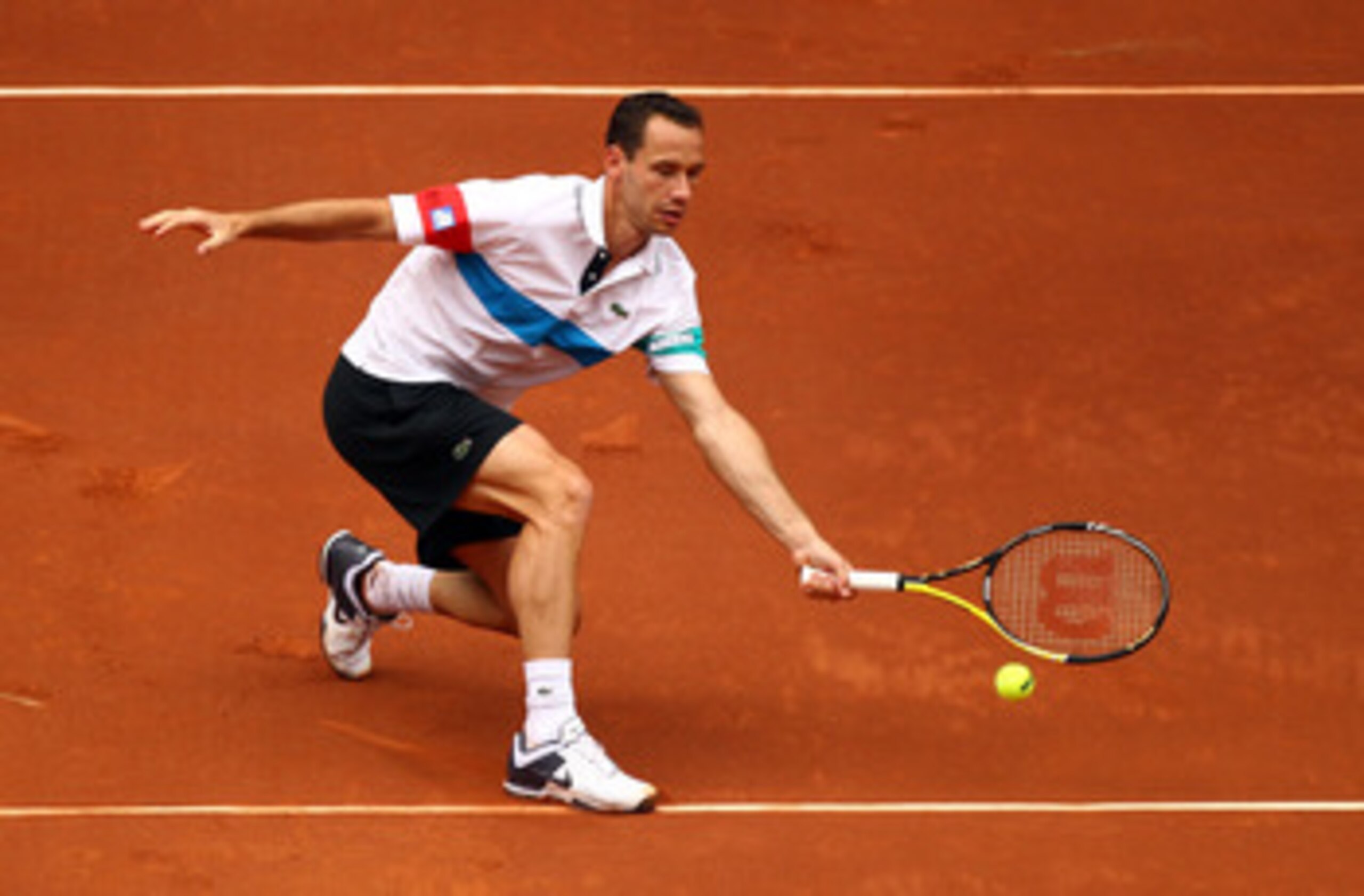 MADRID, SPAIN - MAY 06:  Michael Llodra of France plays a volley in his match against Rafael Nadal of Spain during day seven of the Mutua Madrilena Madrid Open Tennis on May 6, 2011 in Madrid, Spain.  (Photo by Julian Finney/Getty Images)