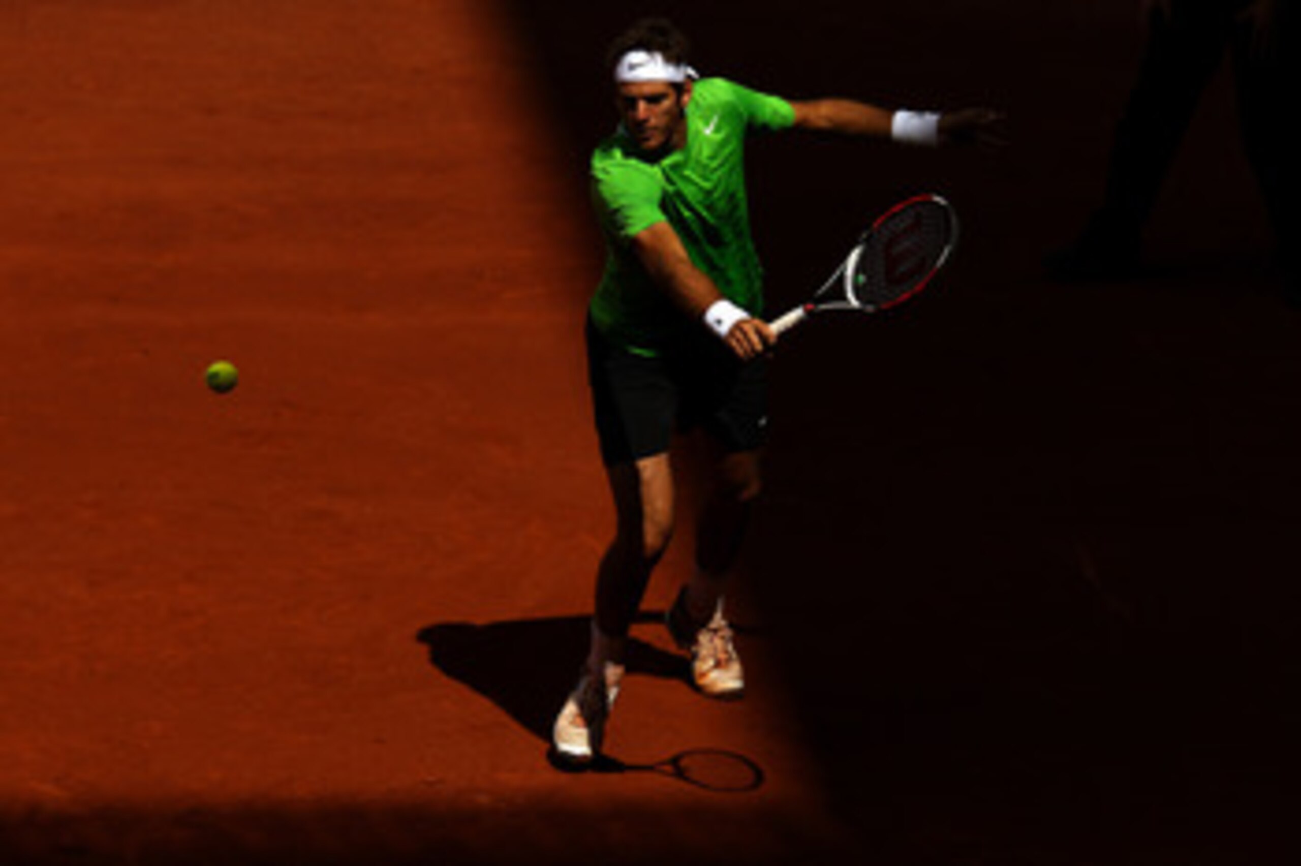 MADRID, SPAIN - MAY 03:  Juan Martin Del Potro of Argentina plays a backhand in his match against Mikhail Youzhny of Russia during day four of the Mutua Madrilena Madrid Open Tennis on May 3, 2011 in Madrid, Spain.  (Photo by Julian Finney/Getty Images)