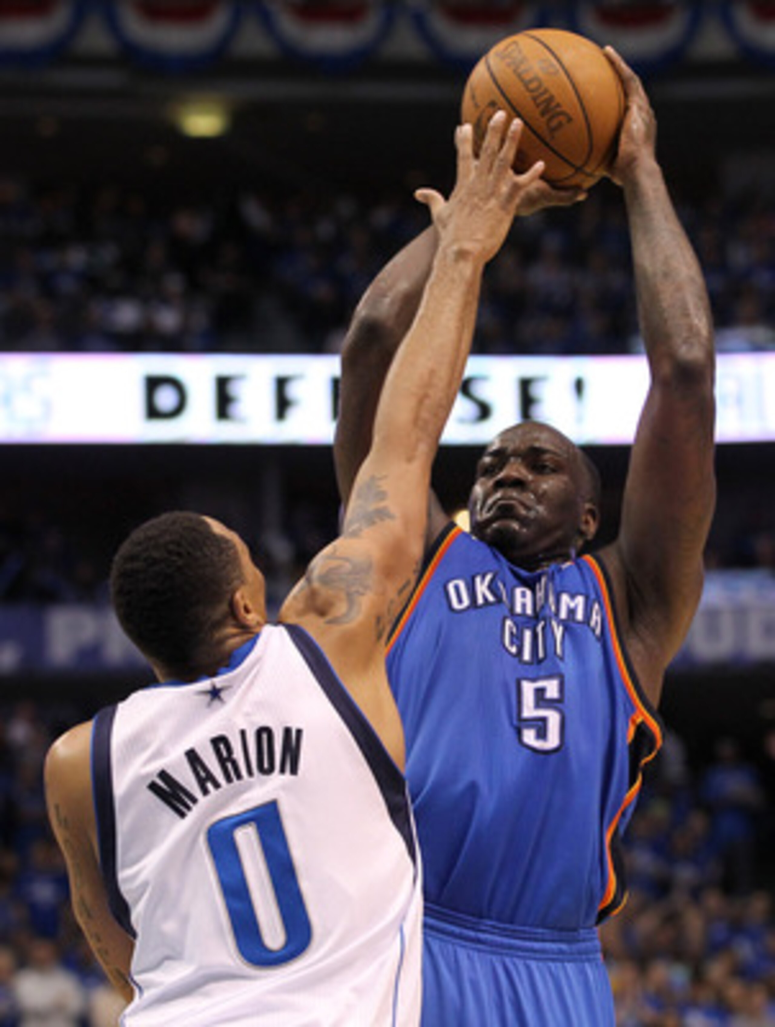 DALLAS, TX - MAY 19:  Kendrick Perkins #5 of the Oklahoma City Thunder shoots over Shawn Marion #0 of the Dallas Mavericks in the third quarter in Game Two of the Western Conference Finals during the 2011 NBA Playoffs at American Airlines Center on May 19