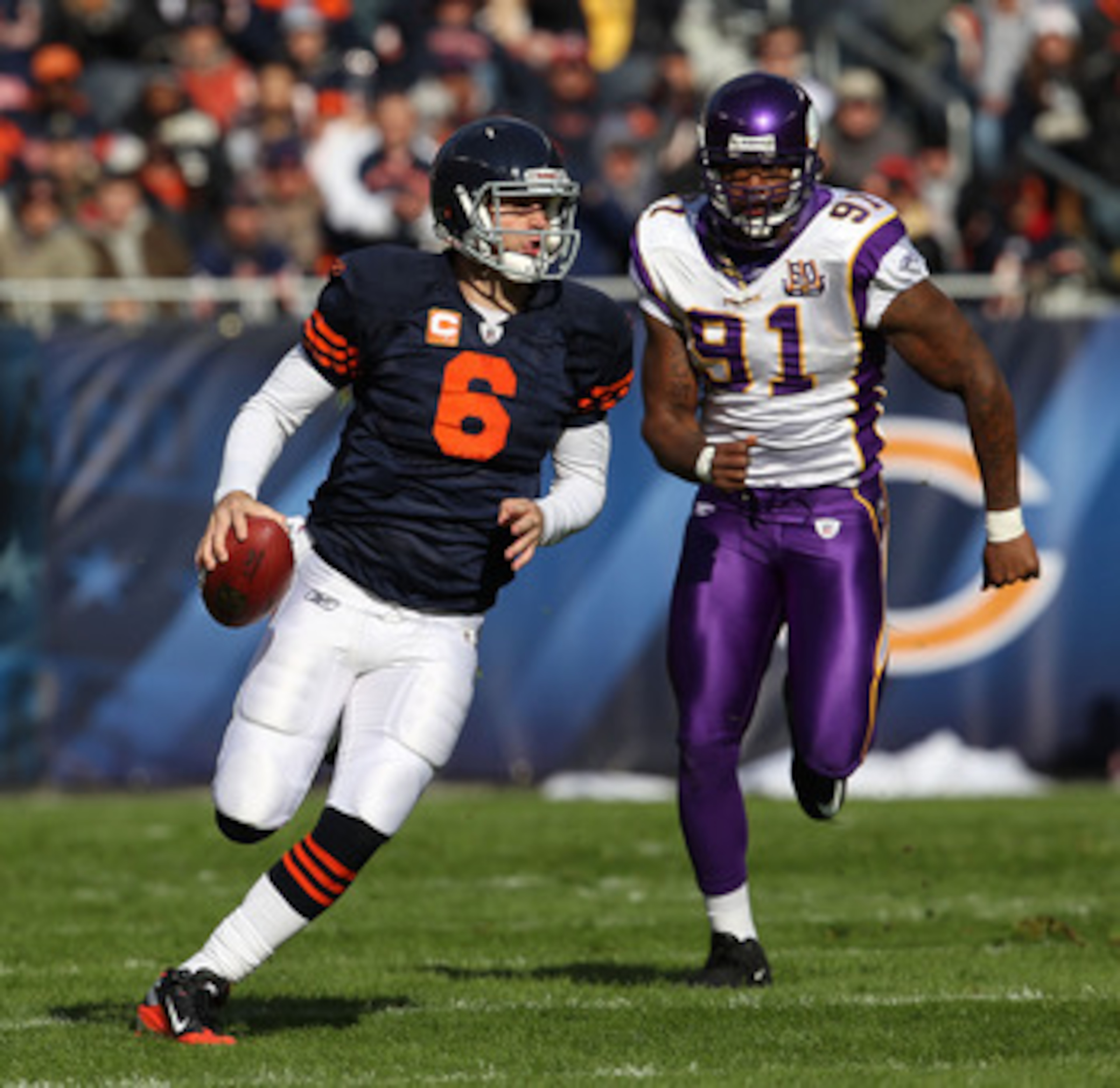CHICAGO - NOVEMBER 14: Jay Cutler #6 of the Chicago Bears runs for a first down as Ray Edwards #91 of the Minnesota Vikings gives chase at Soldier Field on November 14, 2010 in Chicago, Illinois. The Bears defeated the Vikings 27-13. (Photo by Jonathan Da