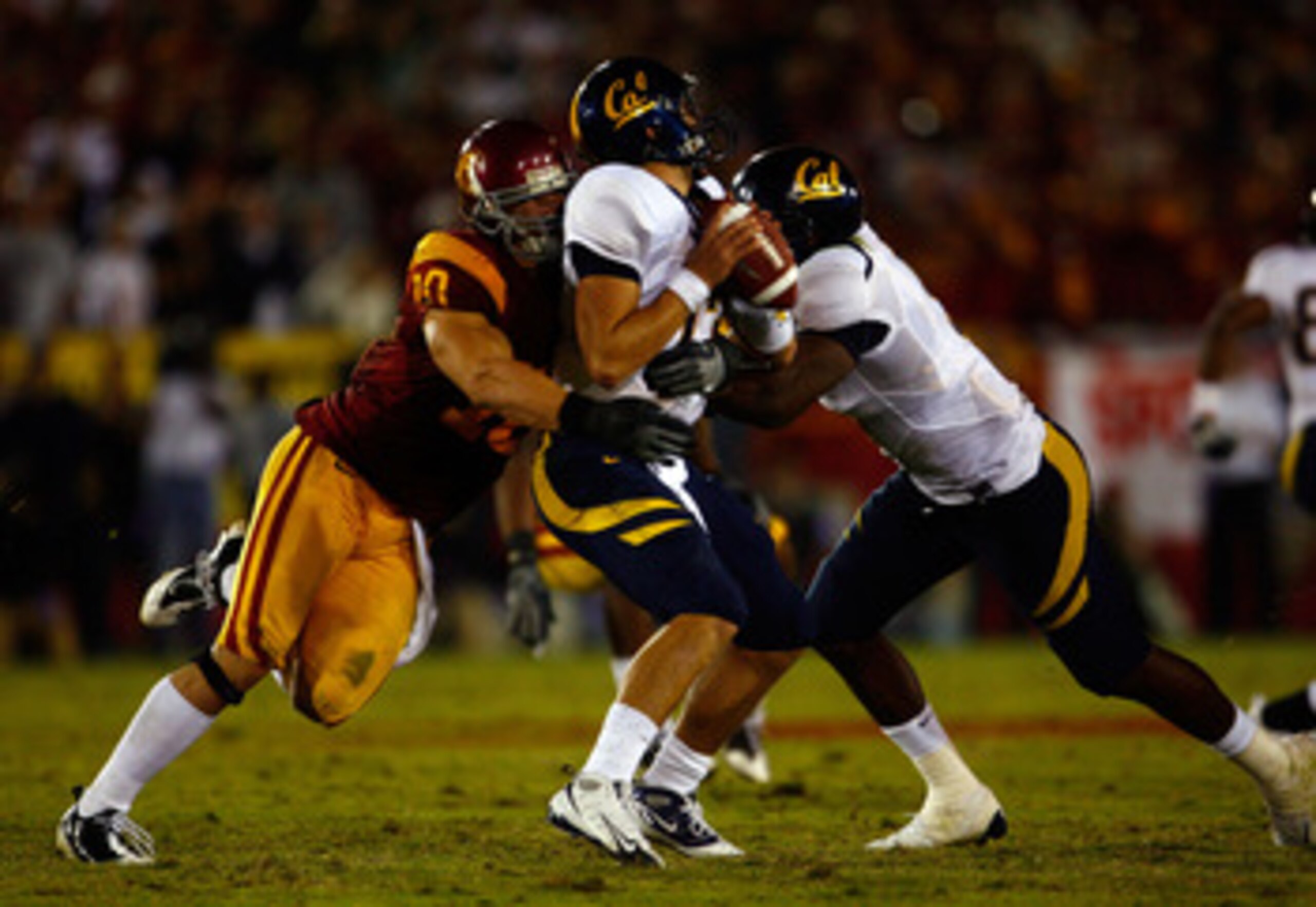 LOS ANGELES, CA - NOVEMBER 08:  Quarterback Kevin Riley #13 of the Cal Golden Bears is sacked by Brian Cushing #10 of the USC Trojans during the fourth quarter at the Memorial Coliseum on November 8, 2008 in Los Angeles, California. USC defeated Cal 17-3.