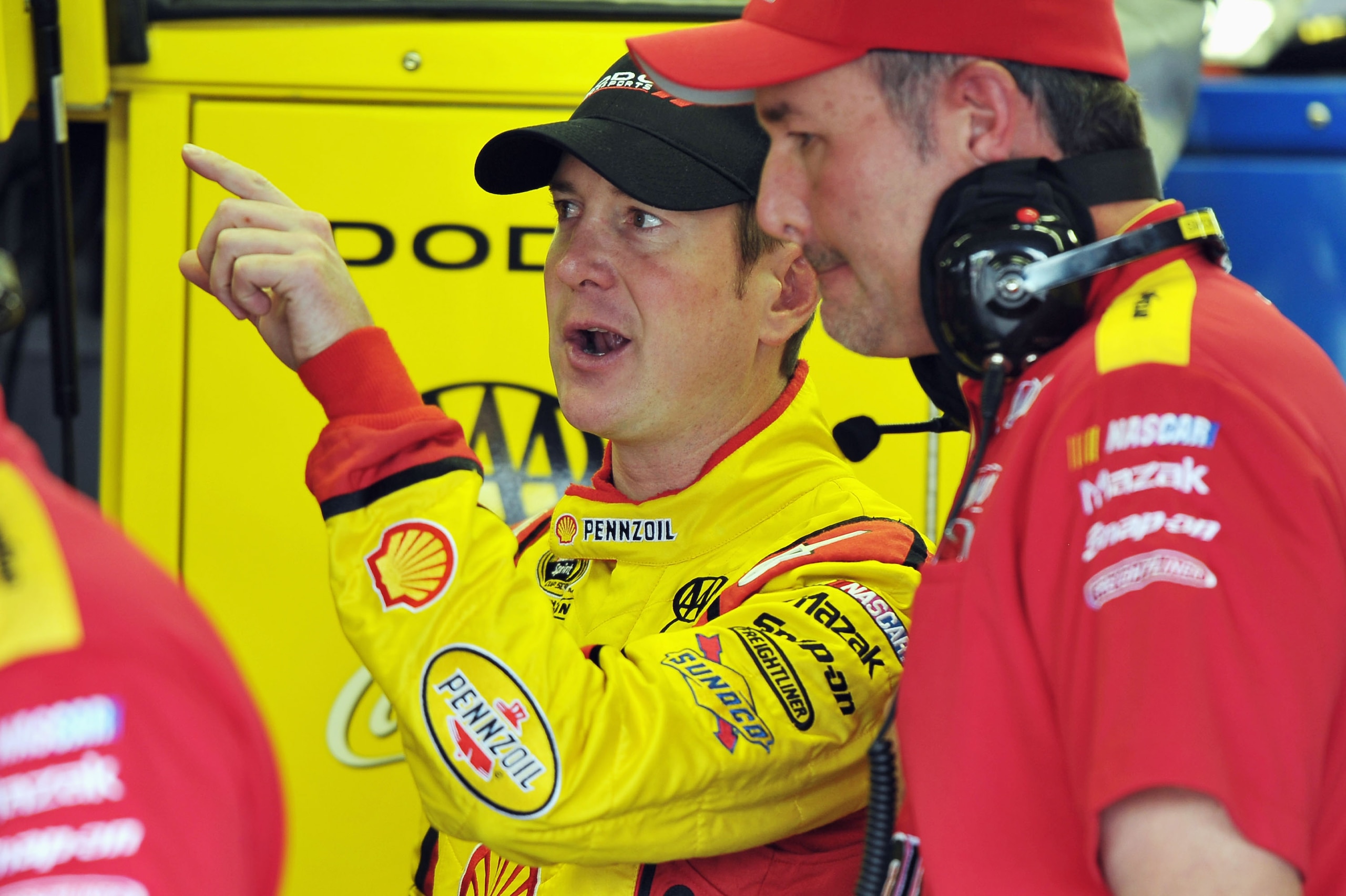 DARLINGTON, SC - MAY 06: Kurt Busch, driver of the #22 Shell/Pennzoil Dodge, talks with a crew member during practice for the NASCAR Sprint Cup Series SHOWTIME Southern 500 at Darlington Raceway on May 6, 2011 in Darlington, South Carolina.  (Photo by Dre