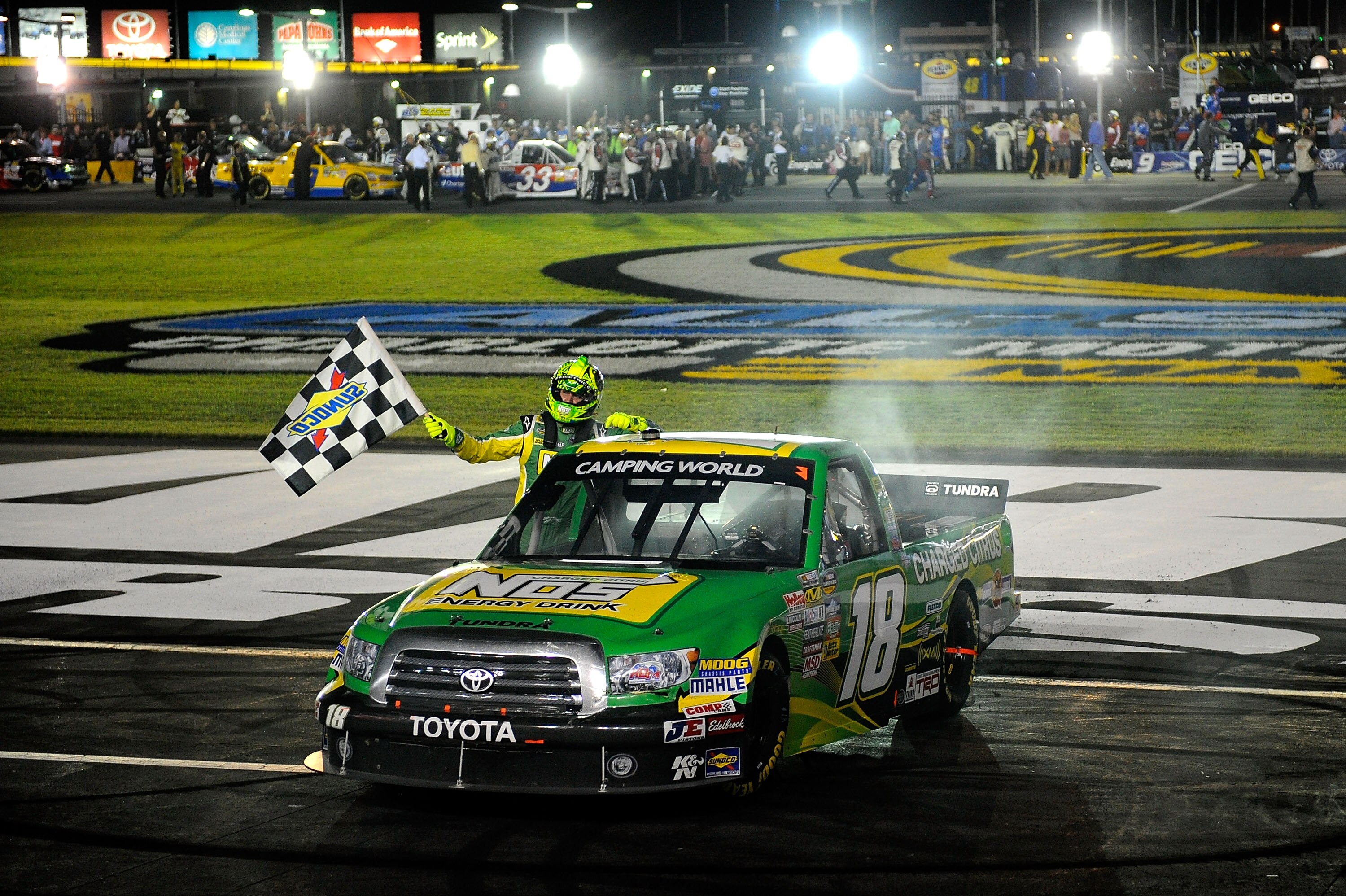 CHARLOTTE, NC - MAY 20:  Kyle Busch, driver of the #18 NOS Energy Drink Toyota, celebrates with the checkered flag after winning the NASCAR Camping World Truck Series North Carolina Education Lottery 200 at Charlotte Motor Speedway on May 20, 2011 in Char