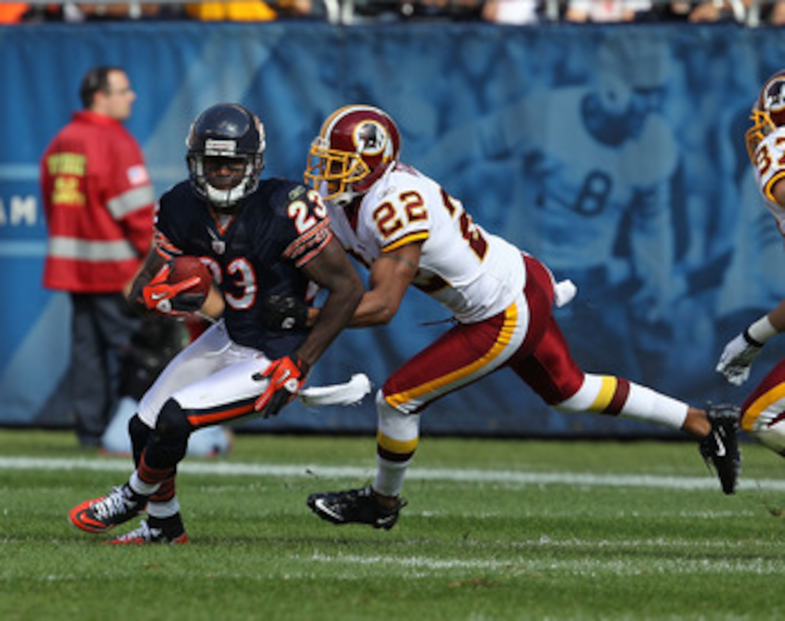 CHICAGO - OCTOBER 24: Devin Hester #23 of the Chicago Bears avoids a tackle attempt by Carlos Rogers #22 of the Washington Redskins at Soldier Field on October 24, 2010 in Chicago, Illinois. The Redskins defeated the Bears 17-14. (Photo by Jonathan Daniel