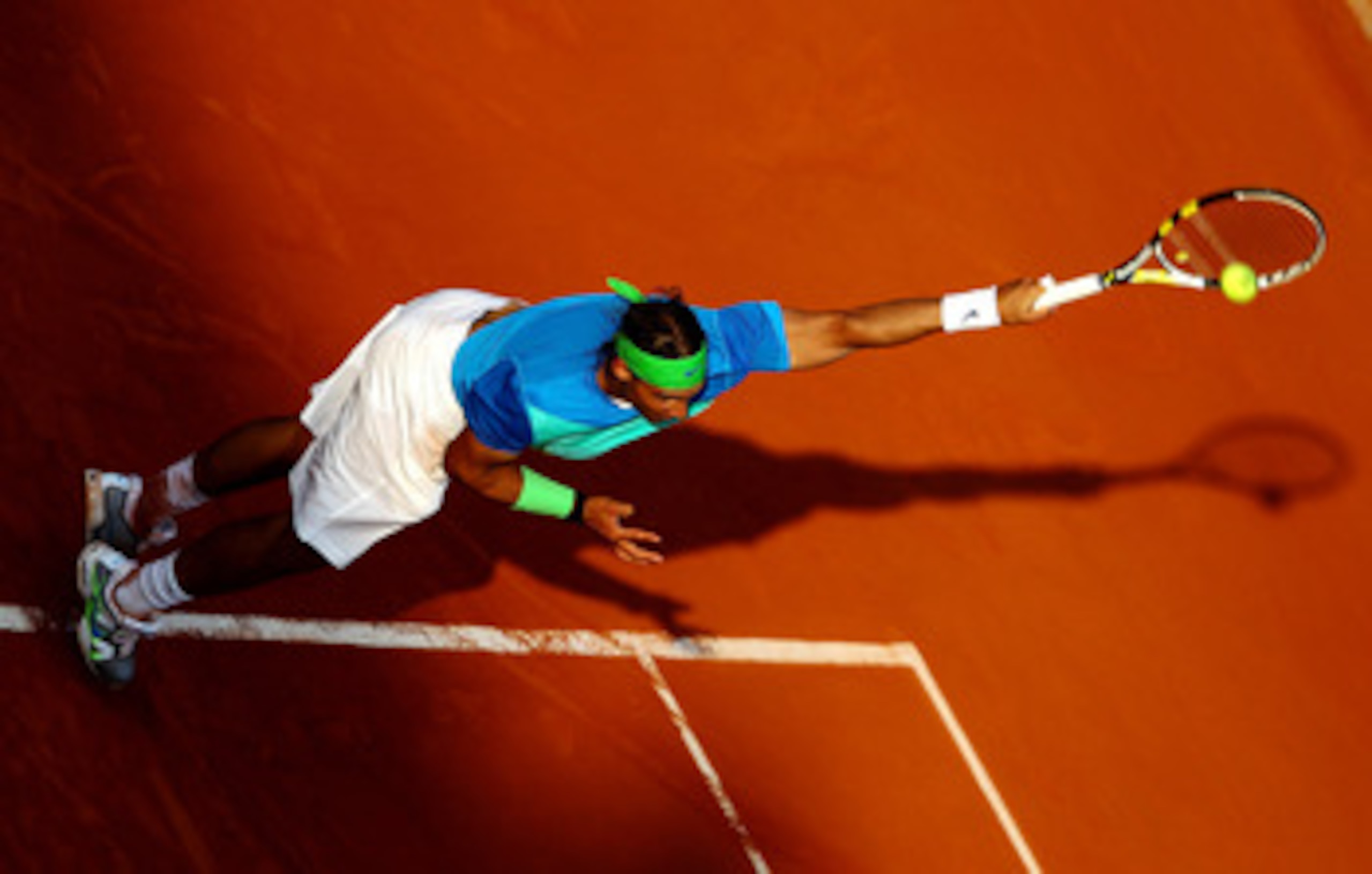 PARIS - JUNE 02: Rafael Nadal of Spain serves during the men's singles quarter final match between Rafael Nadal of Spain and Nicolas Almagro of Spain at the French Open on day eleven of the French Open at Roland Garros on June 2, 2010 in Paris, France. PARIS - JUNE 02: Rafael Nadal of Spain serves during the men's singles quarter final match between Rafael Nadal of Spain and Nicolas Almagro of Spain at the French Open on day eleven of the French Open at Roland Garros on June 2, 2010 in Paris, France.