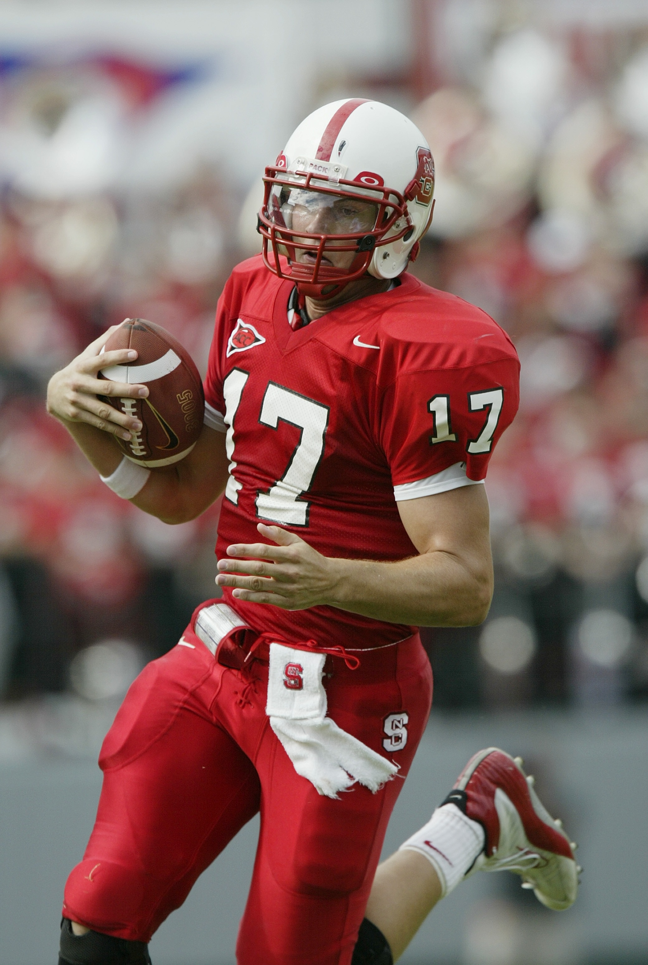 RALEIGH, NC - SEPTEMBER 27:  Quarterback Philip Rivers #17 of the North Carolina State University Wolfpack scrambles with the ball against the University of North Carolina Tar Heels during the game at Carter Finley Stadium on September 27, 2003 in Raleigh