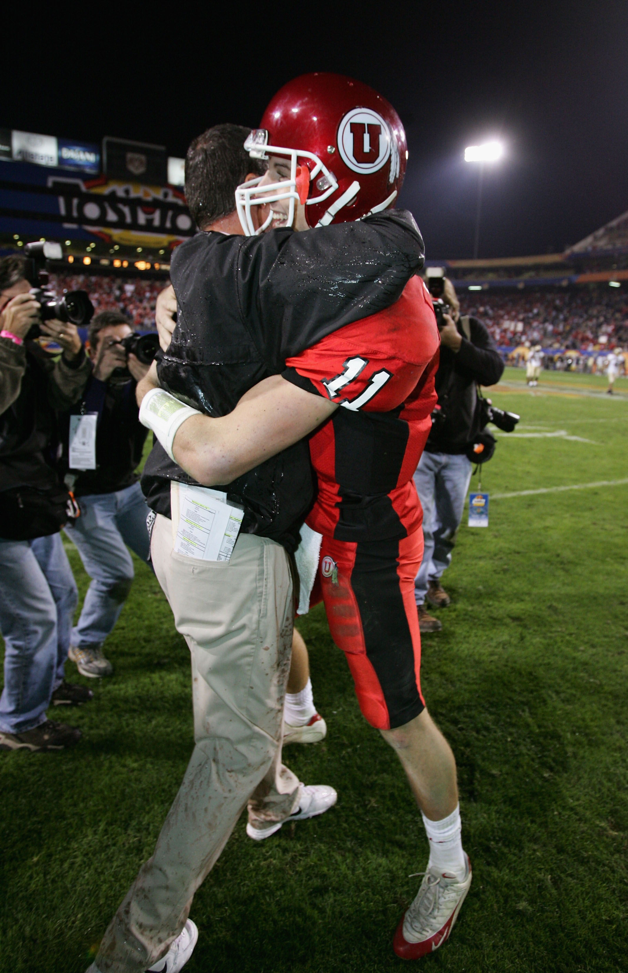 TEMPE, AZ - JANUARY 1:  Quarterback Alex Smith #11 of Utah hugs head coach Urban Meyer after Utah defeated Pittsburgh 35-7 in the Tostito's Fiesta Bowl at the Sun Devil Stadium on January 1, 2005 in Tempe, Arizona.  (Photo by Harry How/Getty Images).