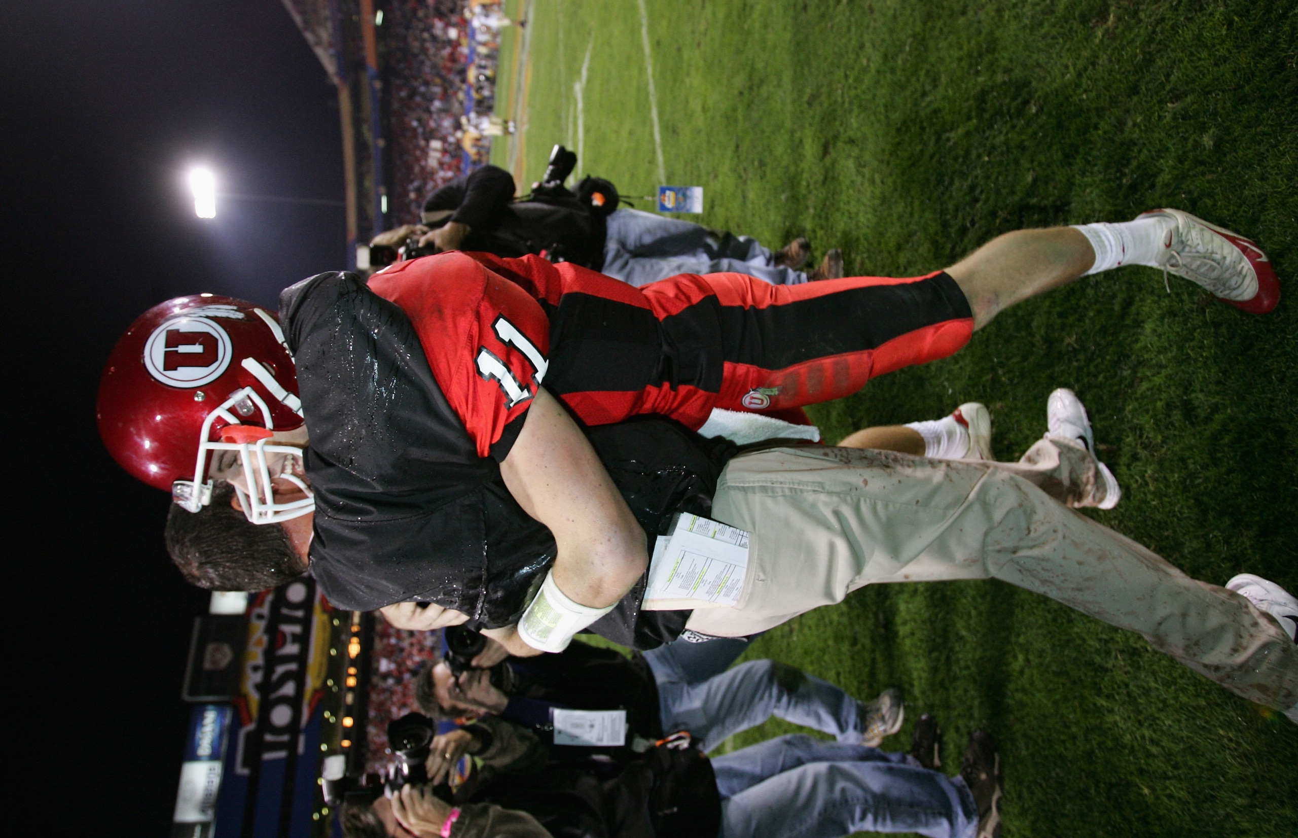 TEMPE, AZ - JANUARY 1: Quarterback Alex Smith #11 of Utah hugs head coach Urban Meyer after Utah defeated Pittsburgh 35-7 in the Tostito's Fiesta Bowl at the Sun Devil Stadium on January 1, 2005 in Tempe, Arizona. (Photo by Harry How/Getty Images). TEMPE, AZ - JANUARY 1: Quarterback Alex Smith #11 of Utah hugs head coach Urban Meyer after Utah defeated Pittsburgh 35-7 in the Tostito's Fiesta Bowl at the Sun Devil Stadium on January 1, 2005 in Tempe, Arizona. (Photo by Harry How/Getty Images).