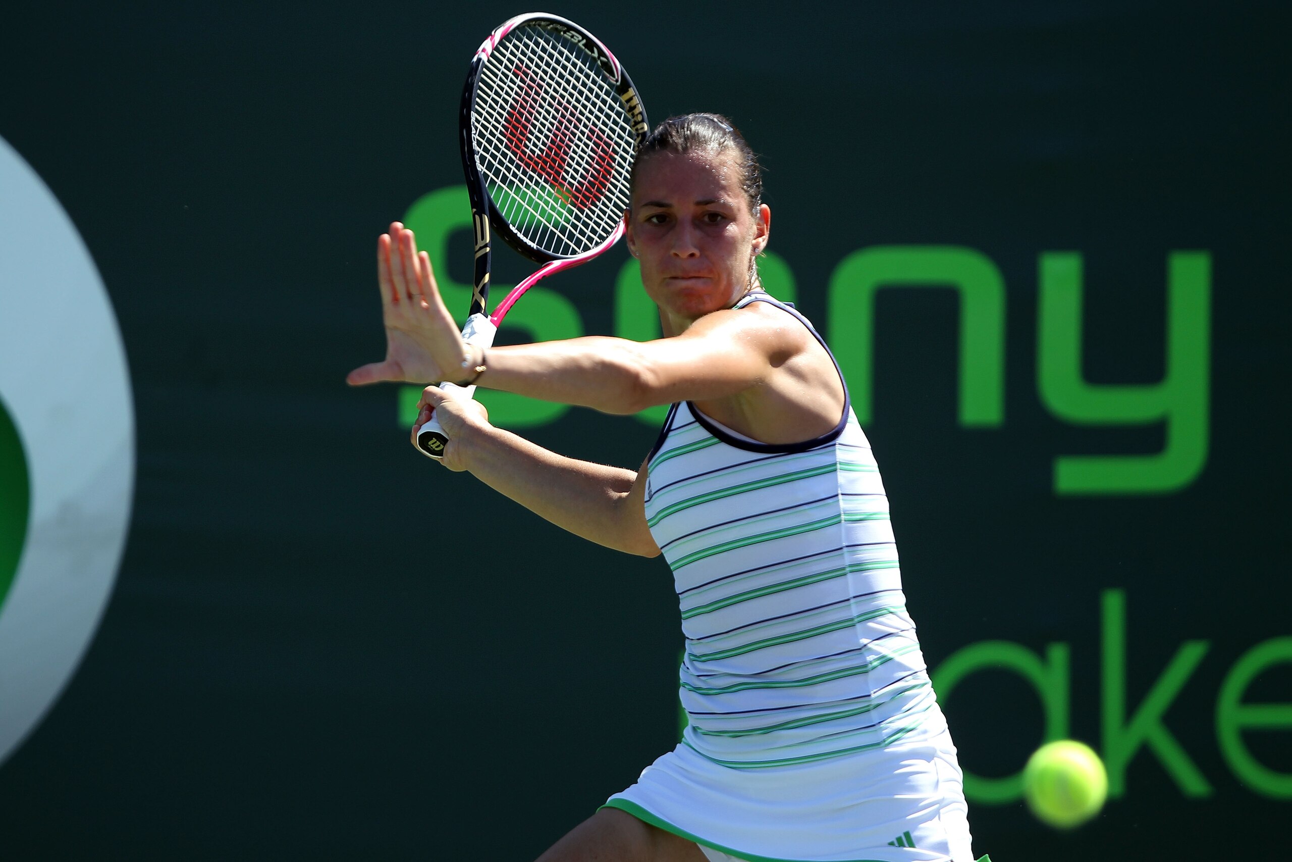 KEY BISCAYNE, FL - MARCH 24:  Flavia Pennetta of Italy hits a forehand return against Iveta Benesova of the Czech Republic during the Sony Ericsson Open at Crandon Park Tennis Center on March 24, 2011 in Key Biscayne, Florida.  (Photo by Clive Brunskill/G