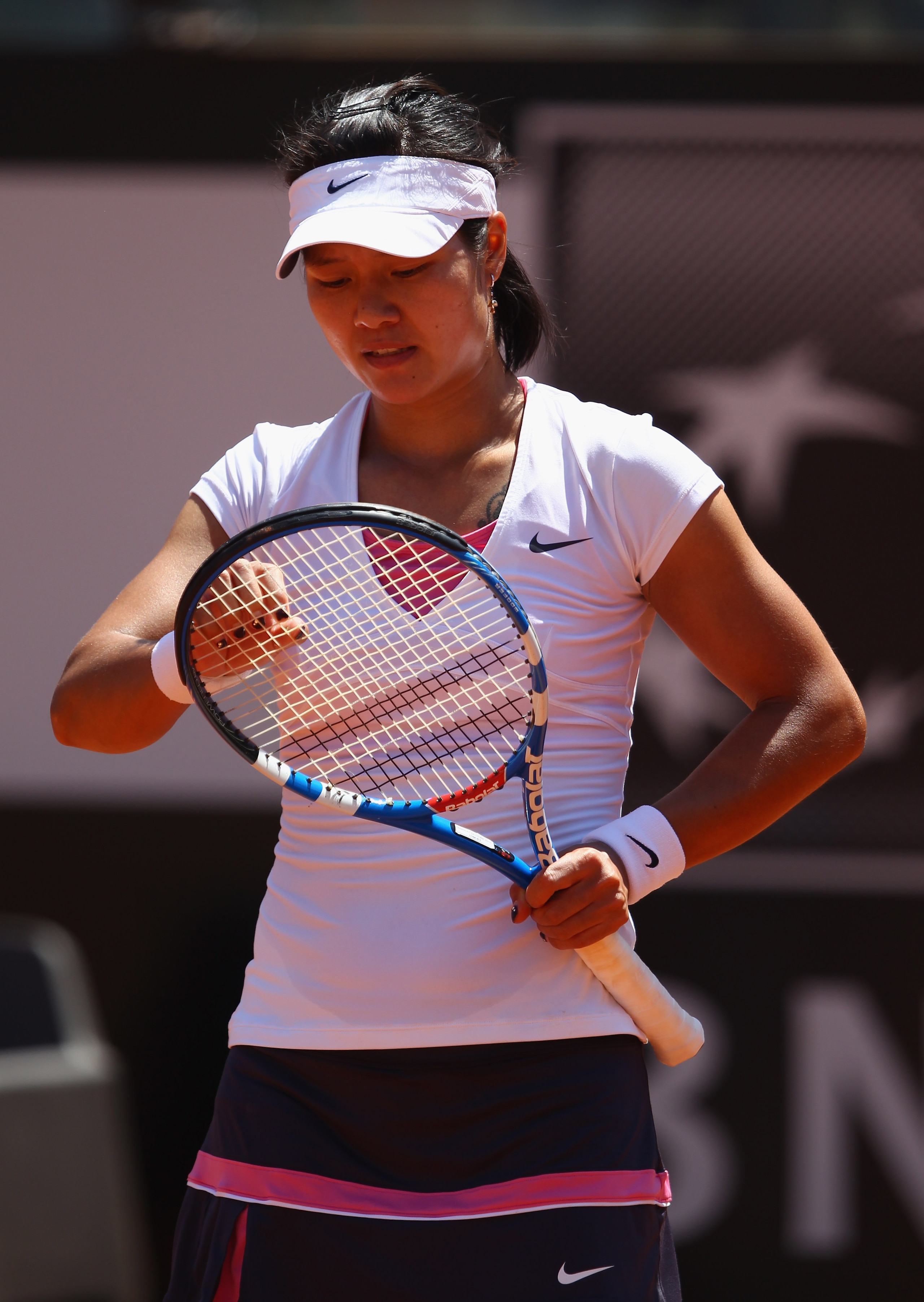 ROME, ITALY - MAY 14:  Li Na of China shows her dejection during her semi final match against Sam Stosur of Australia during day seven of the Internazoinali BNL D'Italia at the Foro Italico Tennis Centre  on May 14, 2011 in Rome, Italy.  (Photo by Clive B