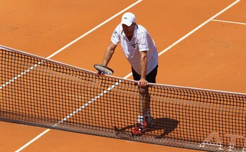 ROME, ITALY - MAY 09:  Andy Roddick of the USA shows his dejection as he leans on the net during his first round match against Gilles Simon of France during day two of the Internazoinali BNL D'Italia at the Foro Italico Tennis Centre on May 9, 2011 in Rom