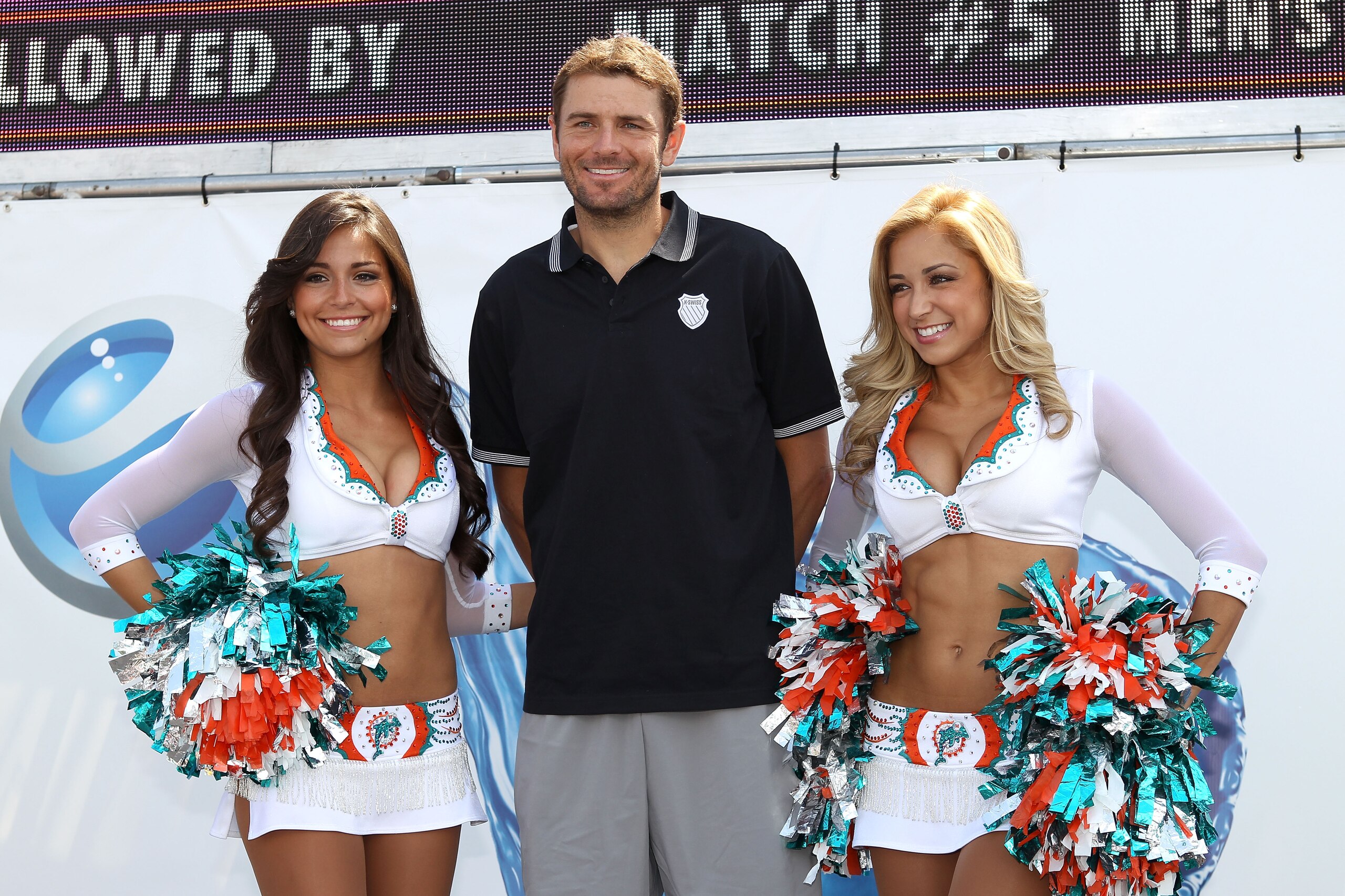 KEY BISCAYNE, FL - MARCH 25:  Mardy Fish poses for a photo with Cheerleaders from the Miami Dolphins during the Sony Ericsson Open at Crandon Park Tennis Center on March 25, 2011 in Key Biscayne, Florida.  (Photo by Clive Brunskill/Getty Images)
