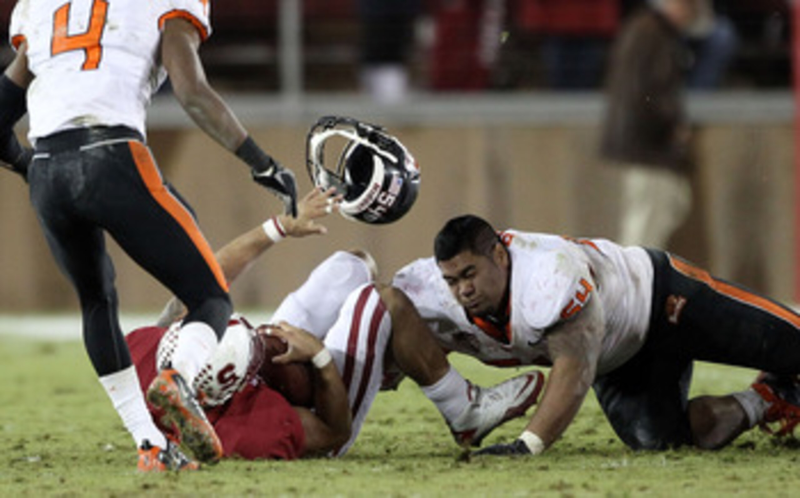 PALO ALTO, CA - NOVEMBER 27:  Stephen Paea #54 of the Oregon State Beavers loses his helmet as he tackles Tyler Gaffney #25 of the Stanford Cardinal at Stanford Stadium on November 27, 2010 in Palo Alto, California.  (Photo by Ezra Shaw/Getty Images)