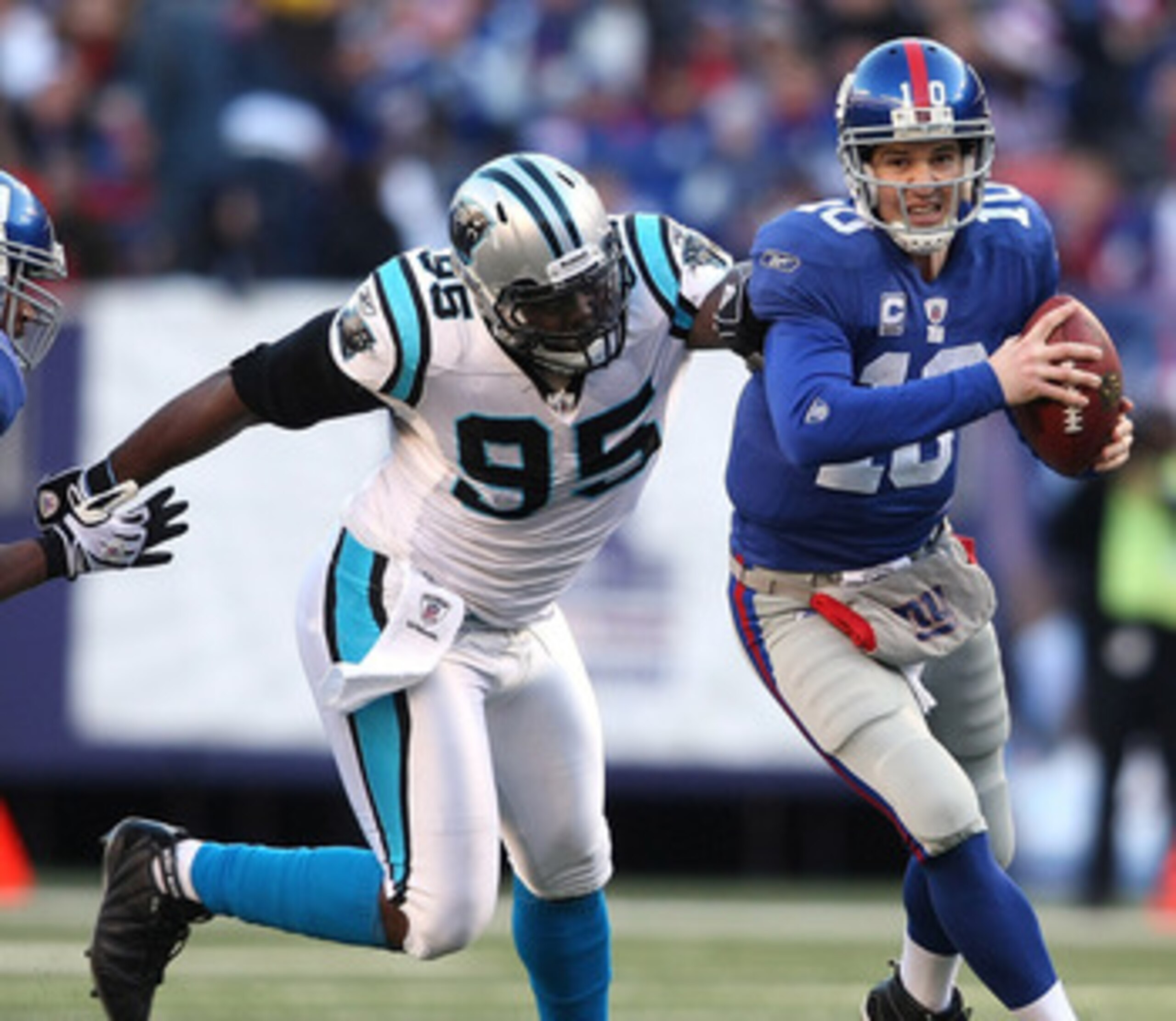 EAST RUTHERFORD, NJ - DECEMBER 27: Eli Manning #10 of the New York Giants is chased down Charles Johnson #95 of the Carolina Panthers at Giants Stadium on December 27, 2009 in East Rutherford, New Jersey. (Photo by Nick Laham/Getty Images) EAST RUTHERFORD, NJ - DECEMBER 27: Eli Manning #10 of the New York Giants is chased down Charles Johnson #95 of the Carolina Panthers at Giants Stadium on December 27, 2009 in East Rutherford, New Jersey. (Photo by Nick Laham/Getty Images)
