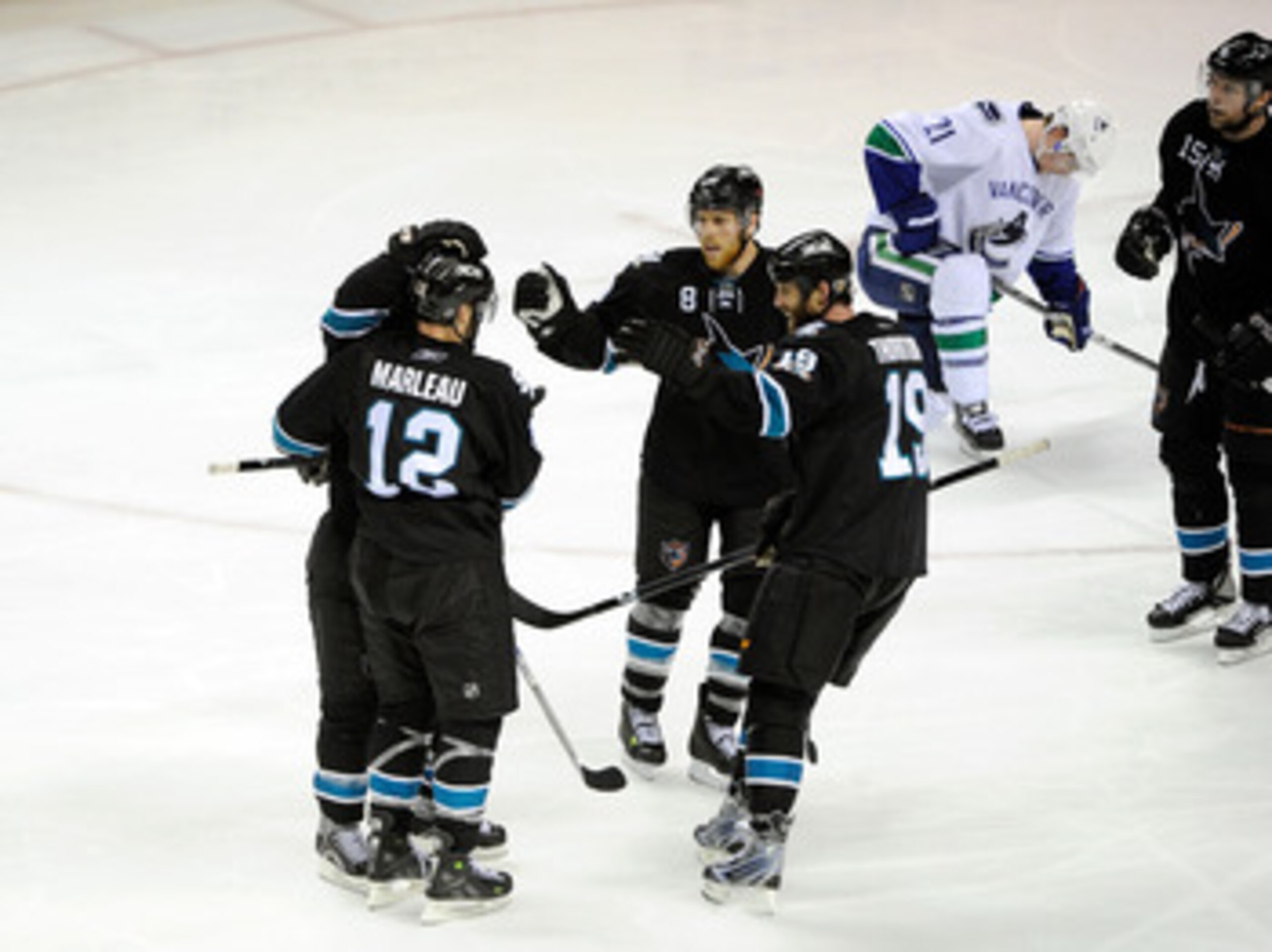 SAN JOSE, CA - MAY 20:  Patrick Marleau #12, Joe Pavelski #8, Joe Thornton #19 and Dany Heatley #15 of the San Jose Sharks celebrate teammate Dan Boyle #22 of the San Jose Sharks' goal in the third period as Mason Raymond #21 of the Vancouver Canucks hang