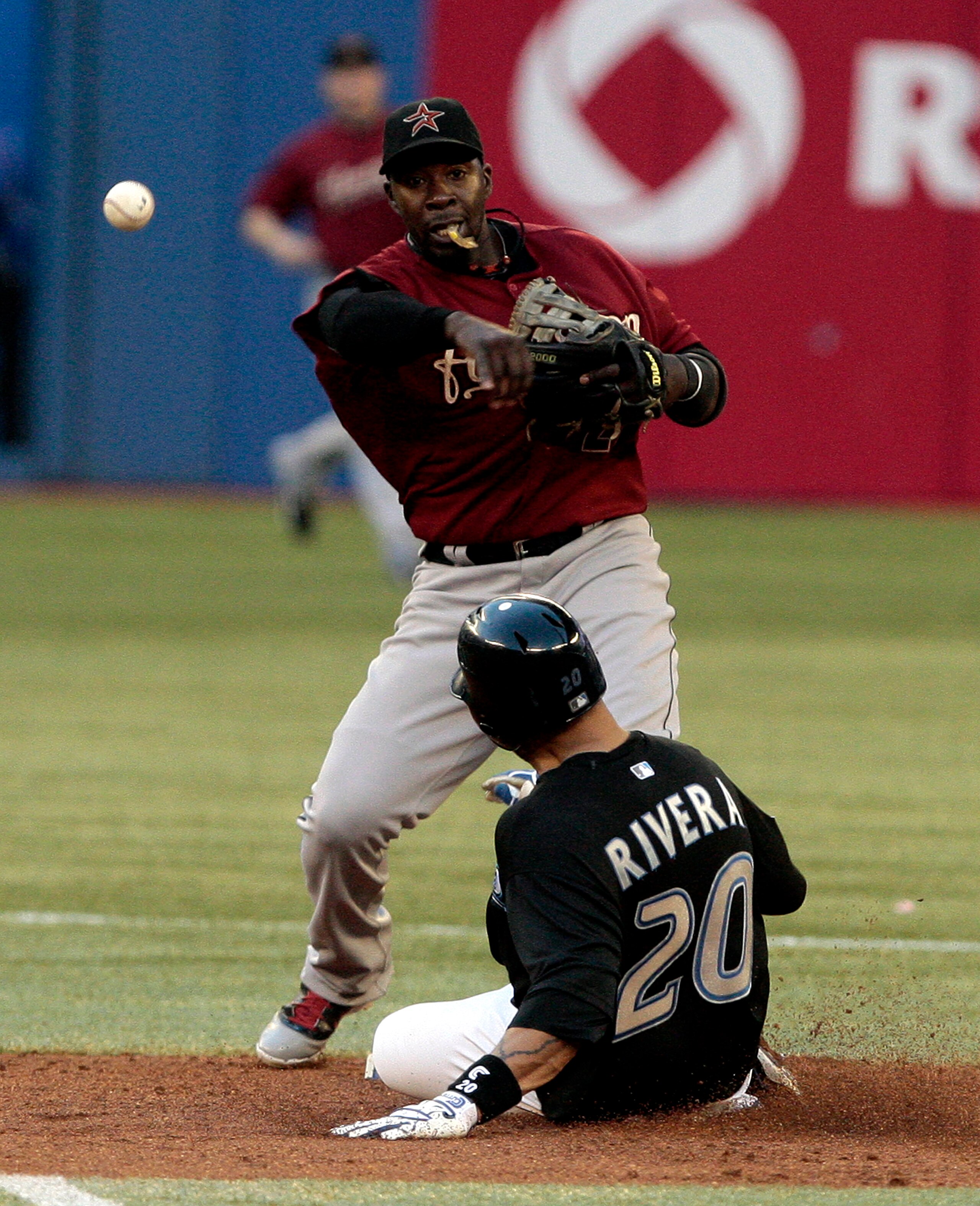 TORONTO, CANADA - MAY 20: Chris Johnson #23 of the Houston Astros makes the double play on Juan Rivera #20 of the Toronto Blue Jays during MLB action at the Rogers Centre May 20, 2011 in Toronto, Ontario, Canada. (Photo by Abelimages/Getty Images)