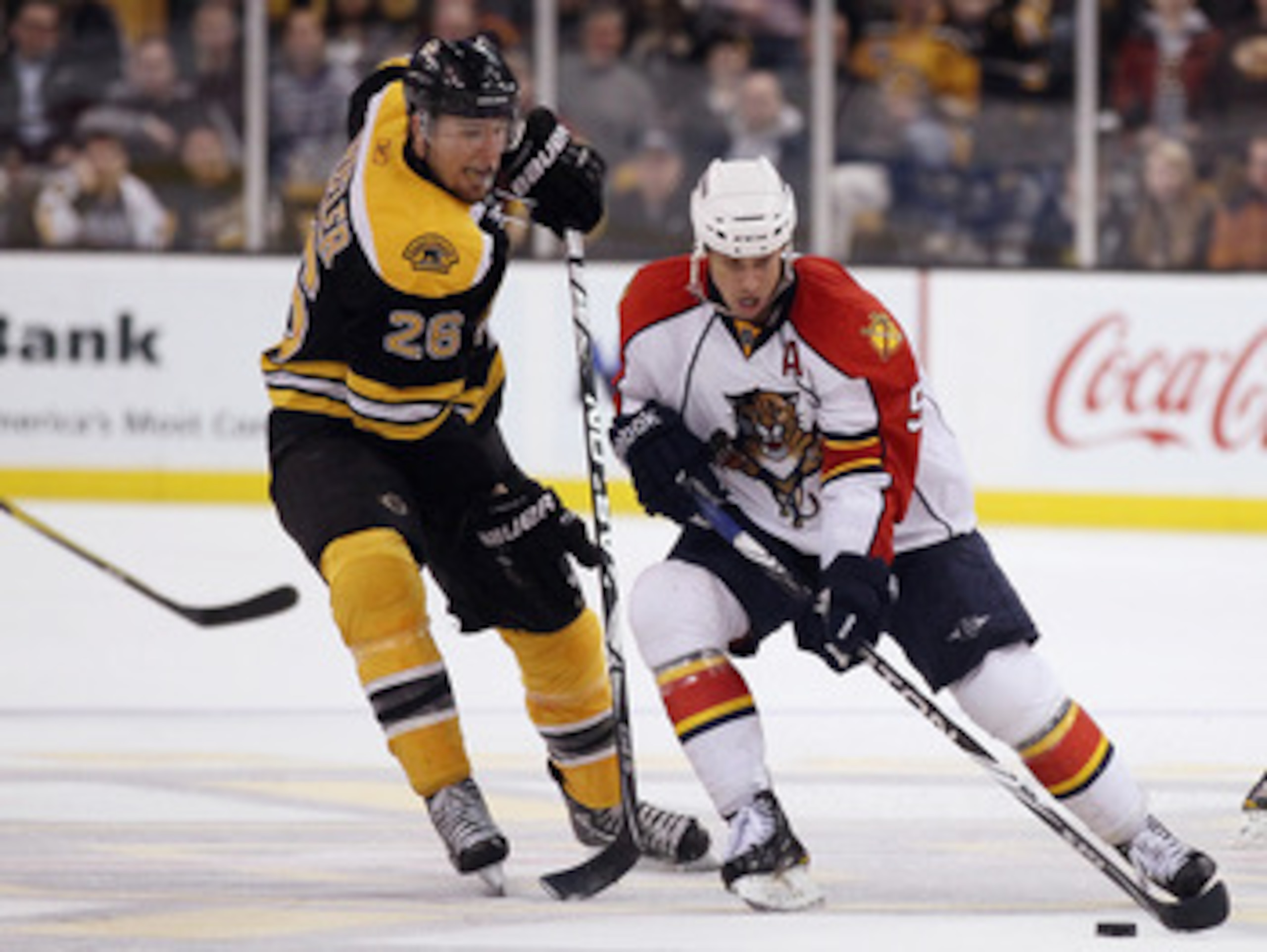 BOSTON, MA - JANUARY 26:  Blake Wheeler #26 of the Boston Bruins tries to get the puck from Stephen Weiss #9 of Florida Panthers on January 26, 2011 at the TD Garden in Boston, Massachusetts. The Bruins defeated the Panthers 2-1.  (Photo by Elsa/Getty Ima