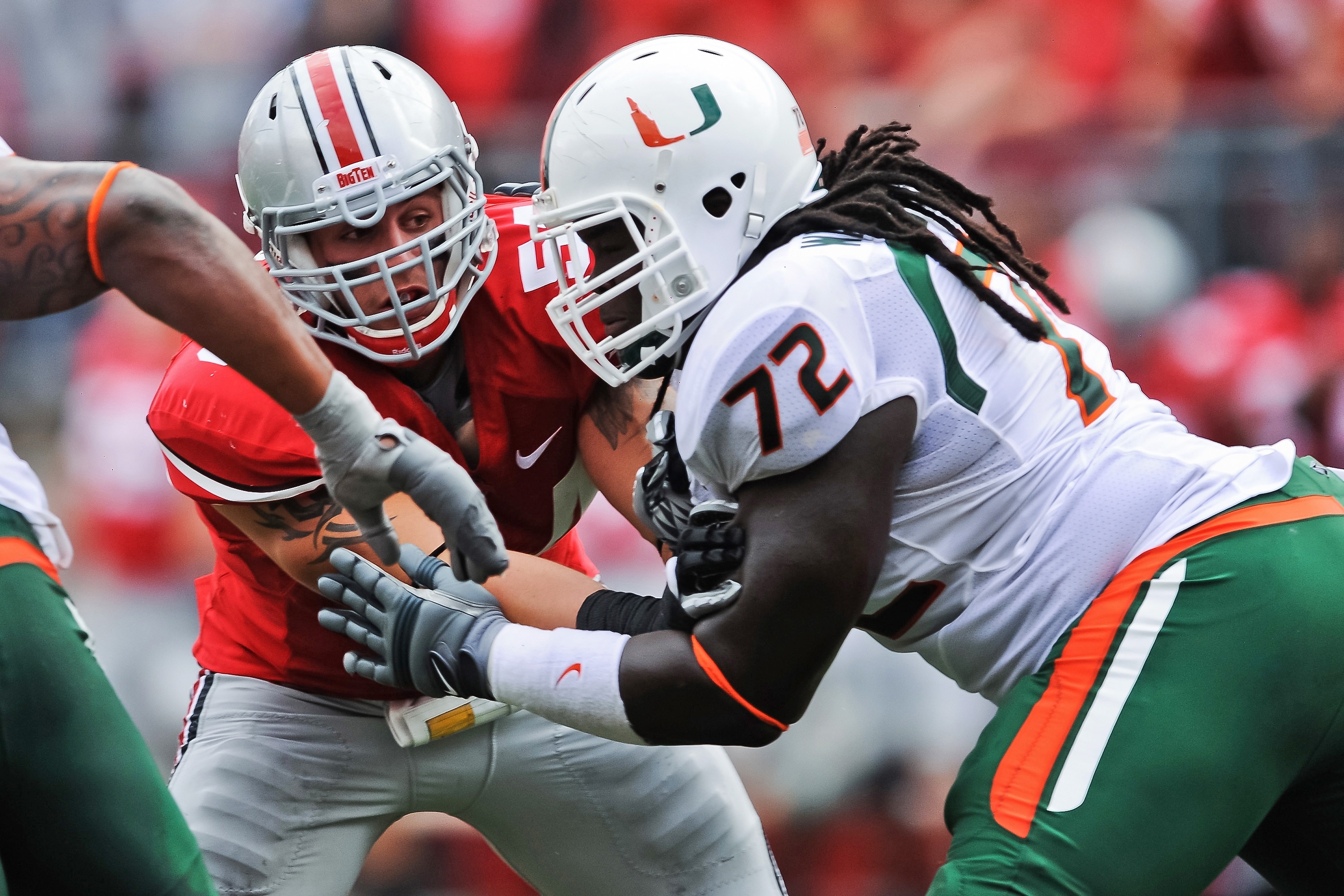 COLUMBUS, OH - SEPTEMBER 11:  John Simon #54 of the Ohio State Buckeyes is blocked by Brandon Washington #72 of the Miami Hurricanes at Ohio Stadium on September 11, 2010 in Columbus, Ohio.  (Photo by Jamie Sabau/Getty Images)
