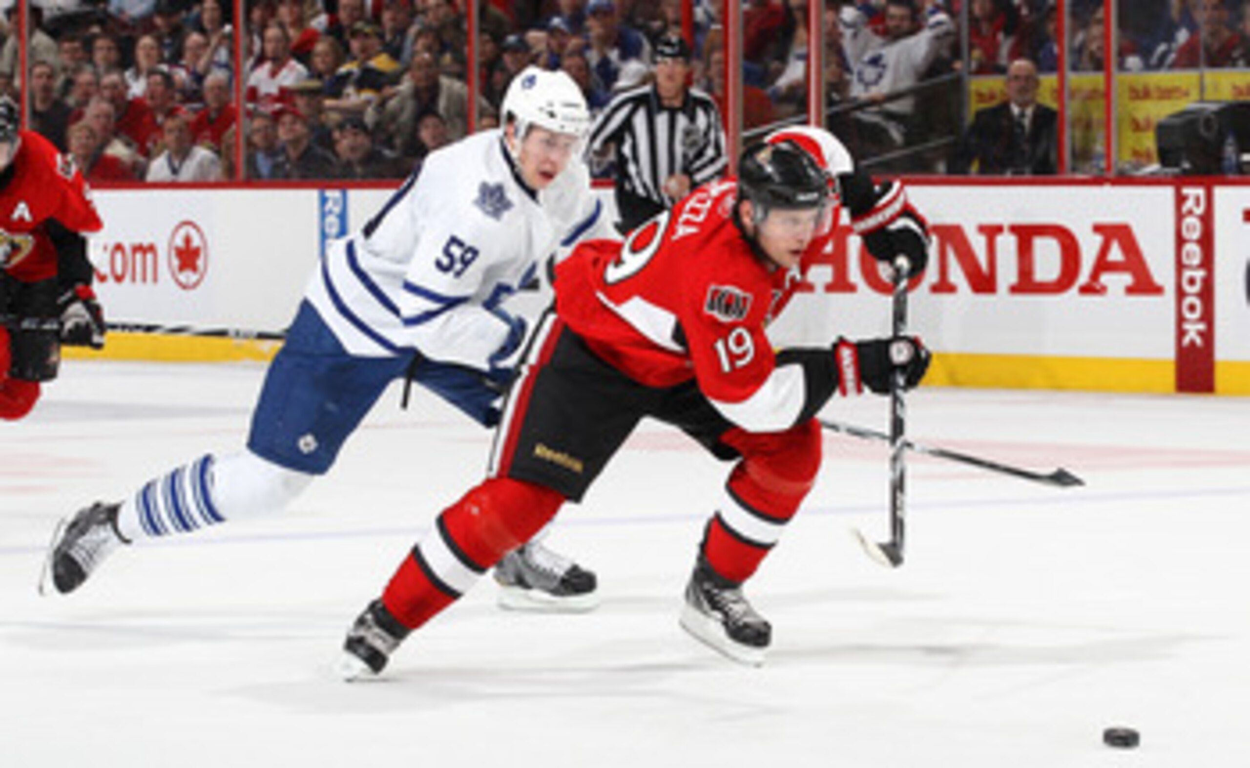 OTTAWA, CANADA - APRIL 2: Jason Spezza #19 of the Ottawa Senators skates with the puck on a break away against Keith Aulie #59 of the Toronto Maple Leafs at Scotiabank Place on April 2, 2011 in Ottawa, Ontario, Canada.  (Photo by Jana Chytilova/Freestyle