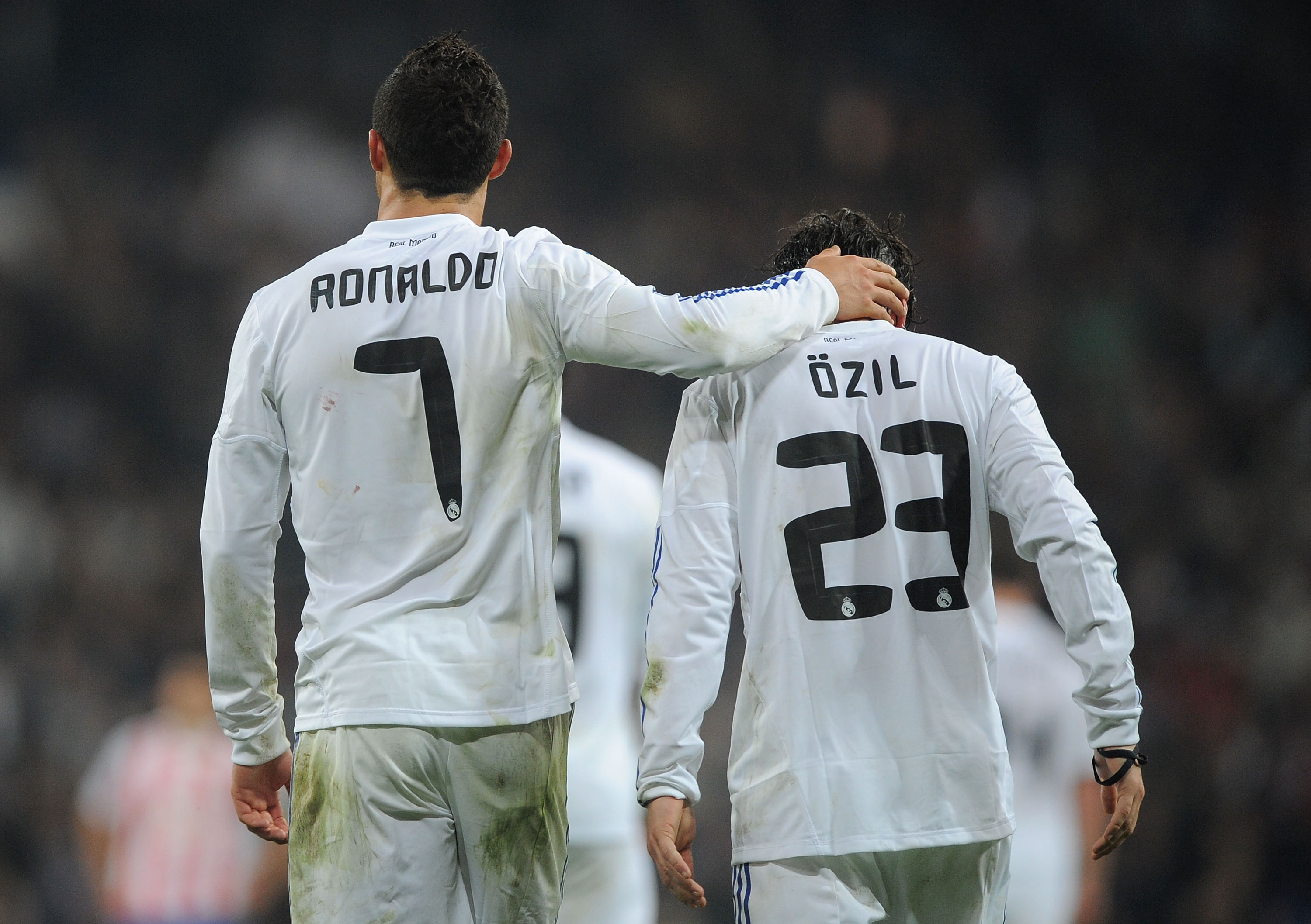 MADRID, SPAIN - JANUARY 13:  Mesut Ozil of Real Madrid celebrates with Cristiano Ronaldo after scoring Real's third goal during the Copa del Rey quarter final first leg match between Real Madrid and Atletico Madrid at Estadio Santiago Bernabeu on January